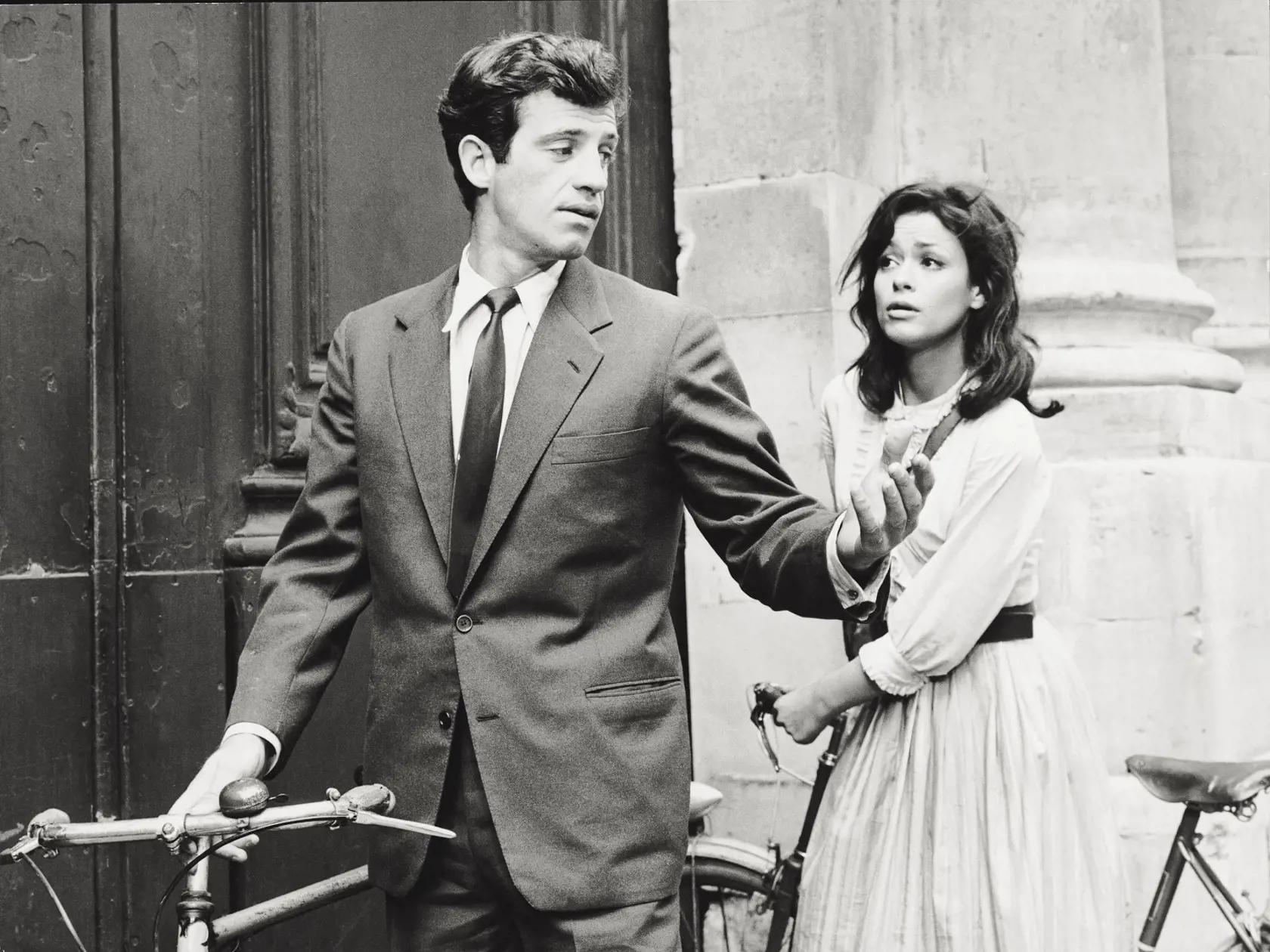 The French actor Jean-Paul Belmondo leaning on a bicycle talking with the French actress Marie Versini in a scene of 'Is Paris Burning?'. 1966 (Photo by Mondadori via Getty Images)