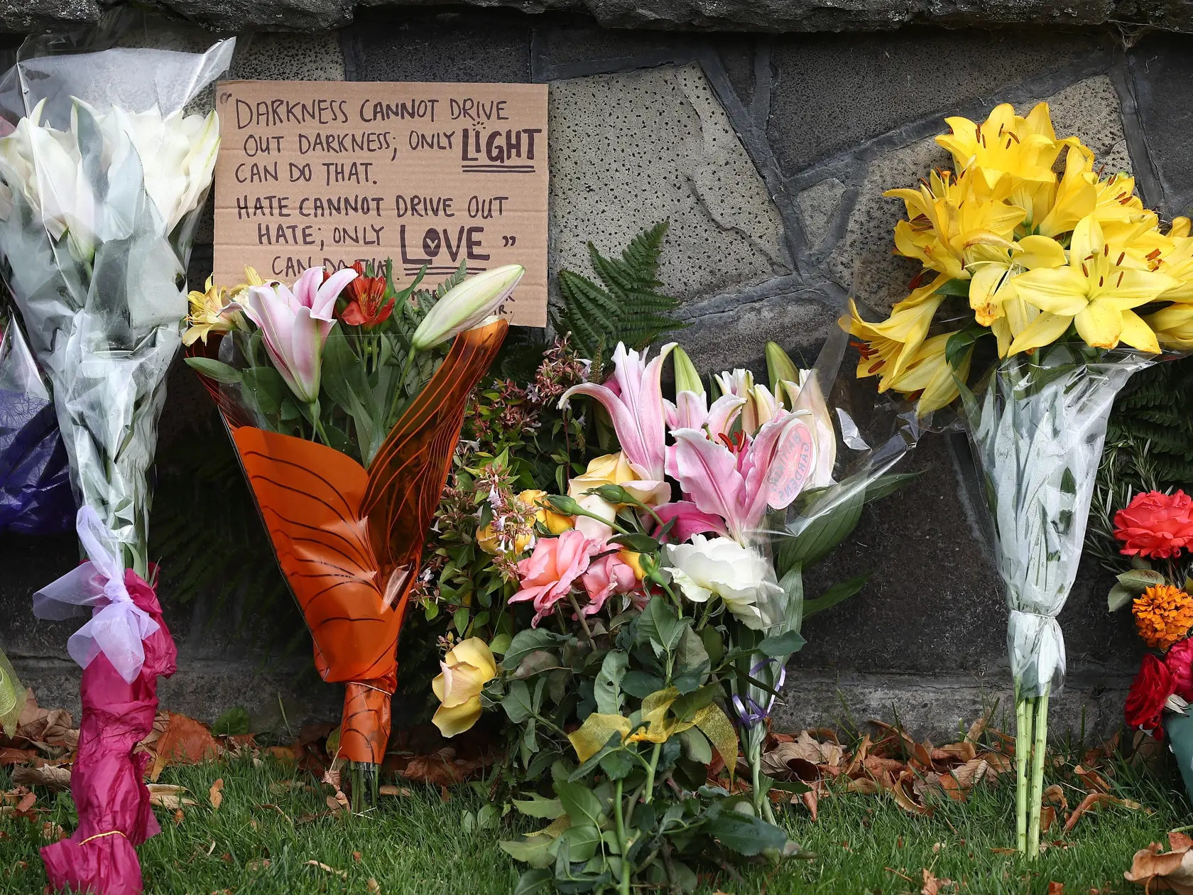 CHRISTCHURCH, NEW ZEALAND - MARCH 16: People gather to lay flowers outside the Botanic Gardens on March 16, 2019 in Christchurch, New Zealand. At least 49 people are confirmed dead, with more than 40 people injured following attacks on two mosques in Christchurch on Friday afternoon. 41 of the victims were killed at Al Noor mosque on Deans Avenue and seven died at Linwood mosque. Another victim died later in Christchurch hospital. Three people are in custody over the mass shootings. One man has 