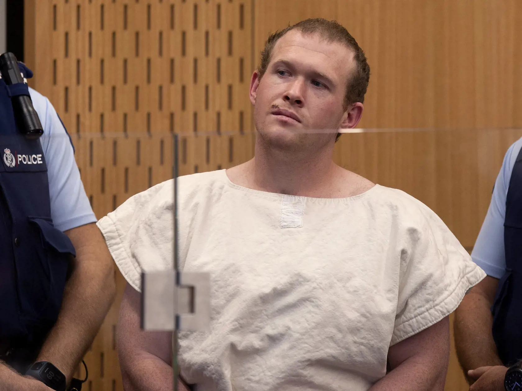 In this Saturday, March 16, 2019 photo, Brenton Tarrant, the man charged in the Christchurch mosque shootings, appears in the Christchurch District Court, in Christchurch, New Zealand. (AP Photo/Mark Mitchell, Pool)