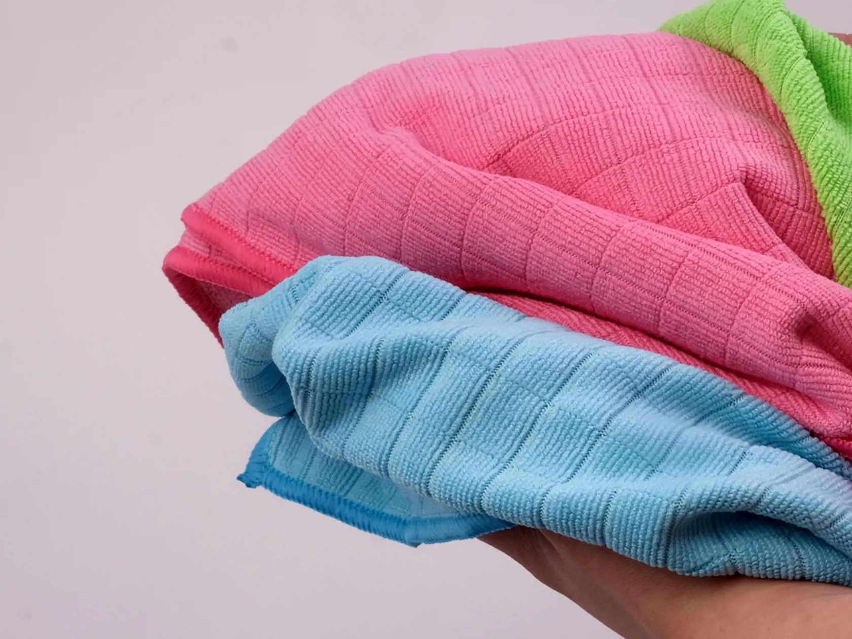 blue ,pink, green micro fiber cloth hand-held textile on white background