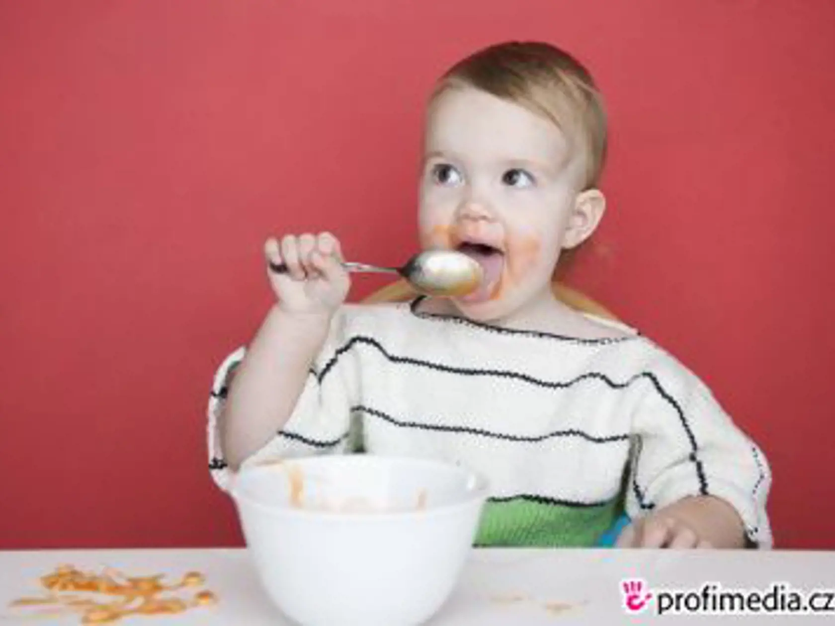 Female toddler eating --- Image by © Royalty-Free/Corbis