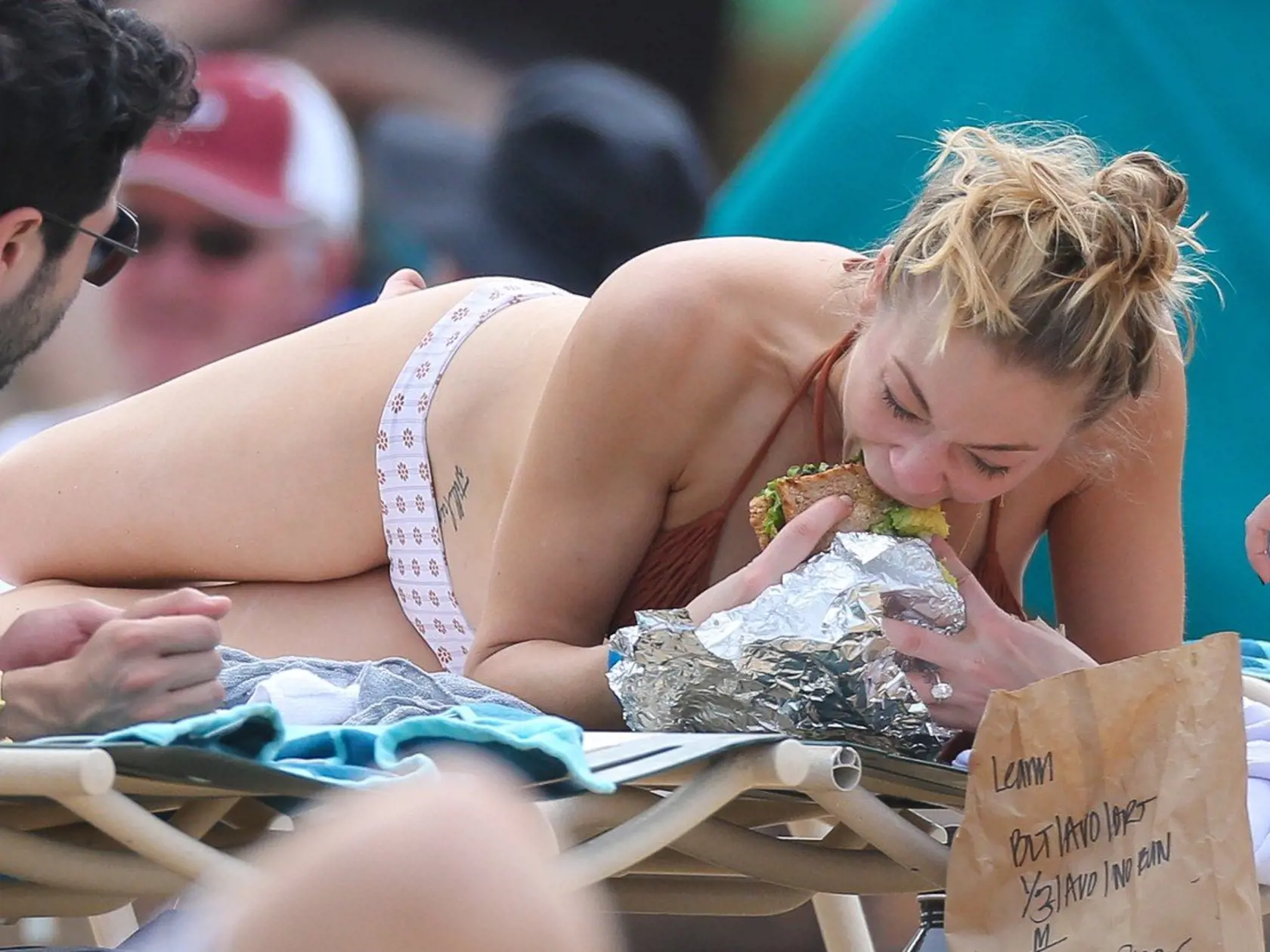 *EXCLUSIVE* Oahu, HI - LeAnn Rimes is seen sunning her fantastic bikini body in the Hawaiian Sun. She was taking a break from filming her reality show with husband Eddie Cibrian. Eddie was seen protecting LeAnn's skin spraying sun tan lotion on her back. Later he played a game of beach bat with a friend on the beach. Leann had a sandwich delivered to her while she soaked up the Sun. **MUST CALL FOR PRICING** **SHOT ON 02/05/14**          February 6, 2014, Image: 183846566, License: Rights-manage