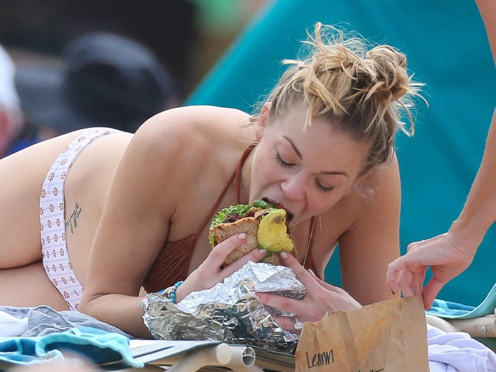 *EXCLUSIVE* Oahu, HI - LeAnn Rimes is seen sunning her fantastic bikini body in the Hawaiian Sun. She was taking a break from filming her reality show with husband Eddie Cibrian. Eddie was seen protecting LeAnn's skin spraying sun tan lotion on her back. Later he played a game of beach bat with a friend on the beach. Leann had a sandwich delivered to her while she soaked up the Sun. **MUST CALL FOR PRICING** **SHOT ON 02/05/14**          February 6, 2014, Image: 183846522, License: Rights-manage