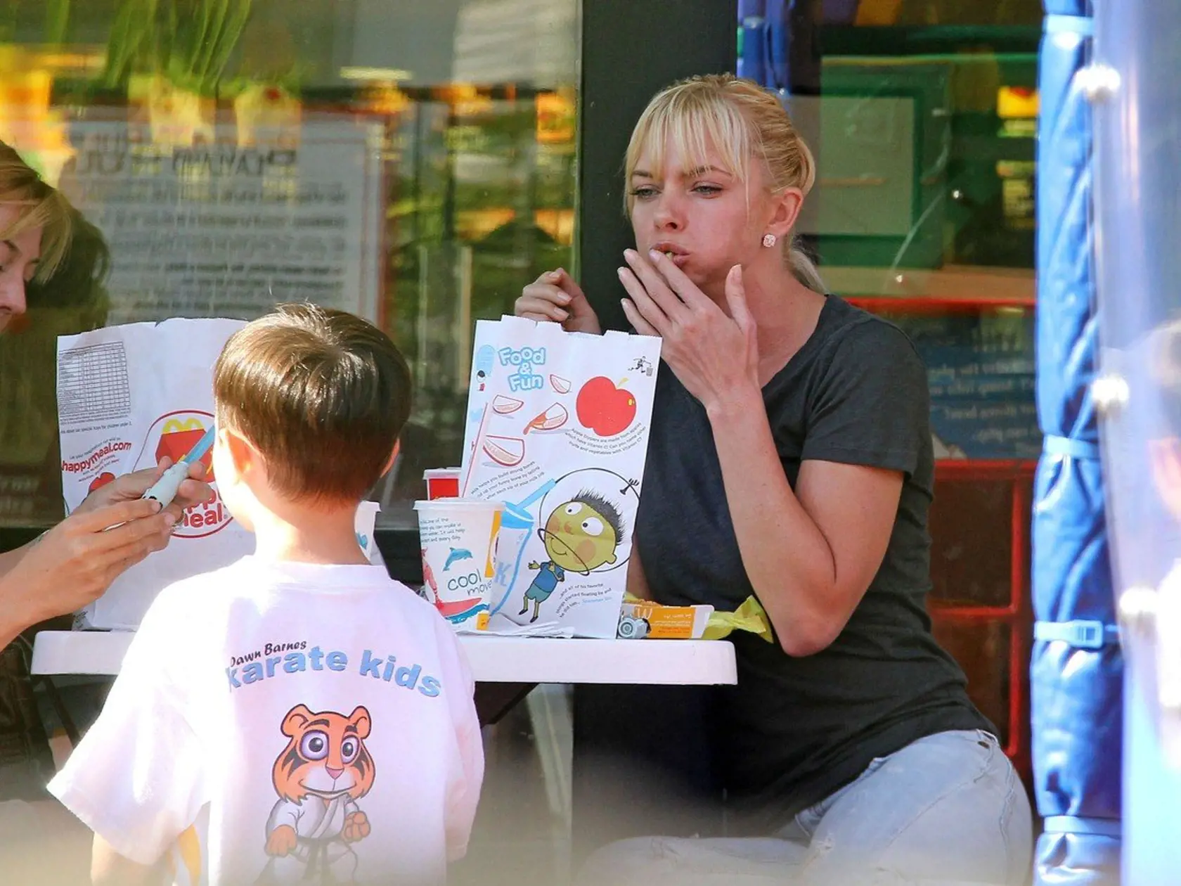 ***EXCLUSIVE*** LOS ANGELES, CA - JULY 11: Actress Jaime Pressly holds the hand of her son Dezi James after picking him up from his weekly karate class on July 11, 2011 in Los Angeles, Callifornia. Jaime heads over to a local McDonald's to meet up with a friend and her son for a play date. Jaime ate a burger and cleaned up on Dezi's french fries. The mother son duo picked up a DVD from a Redbox location and headed home., Image: 96531960, License: Rights-managed, Restrictions: *** Sales in UK, An