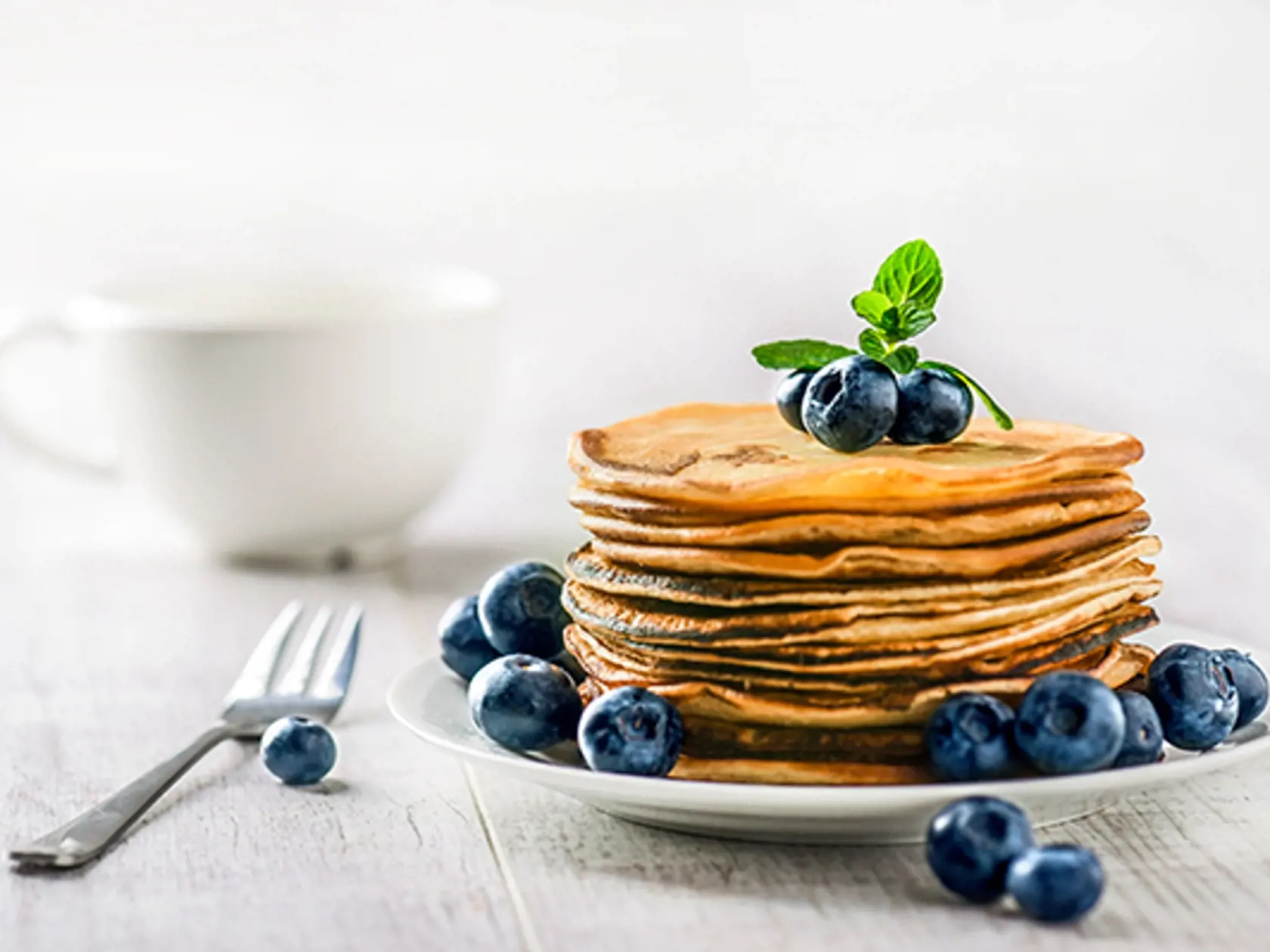 Pancakes,With,Blueberries,And,Mint,Leaf,On,Top.,Pile,Of