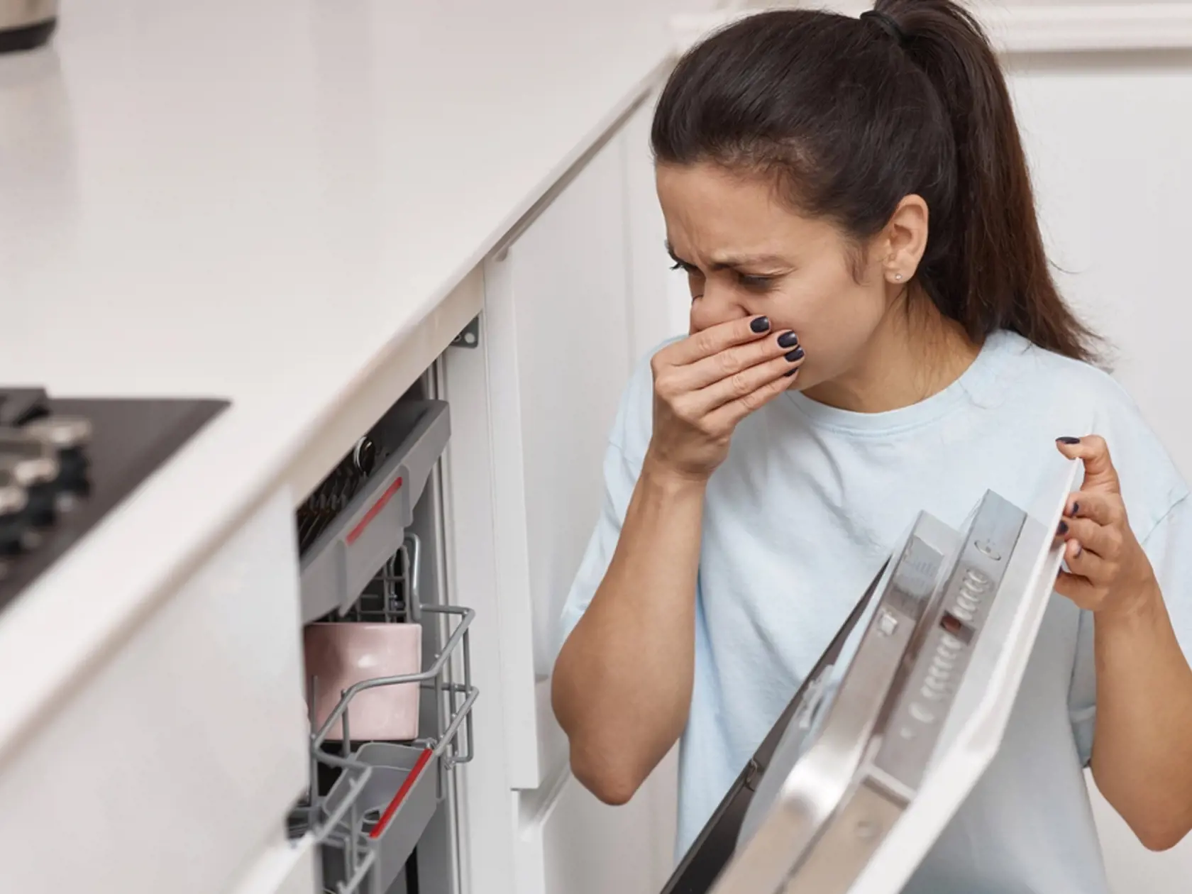 Woman,Smells,Strange,And,Terrible,Smell,Coming,From,Dishwasher,Machine