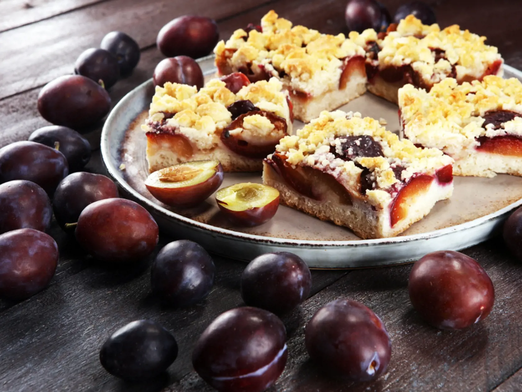 Rustic,Plum,Cake,On,Wooden,Background,With,Plums,Around