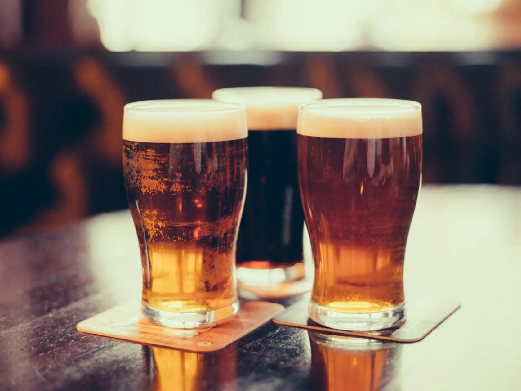 Glasses,Of,Light,And,Dark,Beer,On,A,Pub,Background.