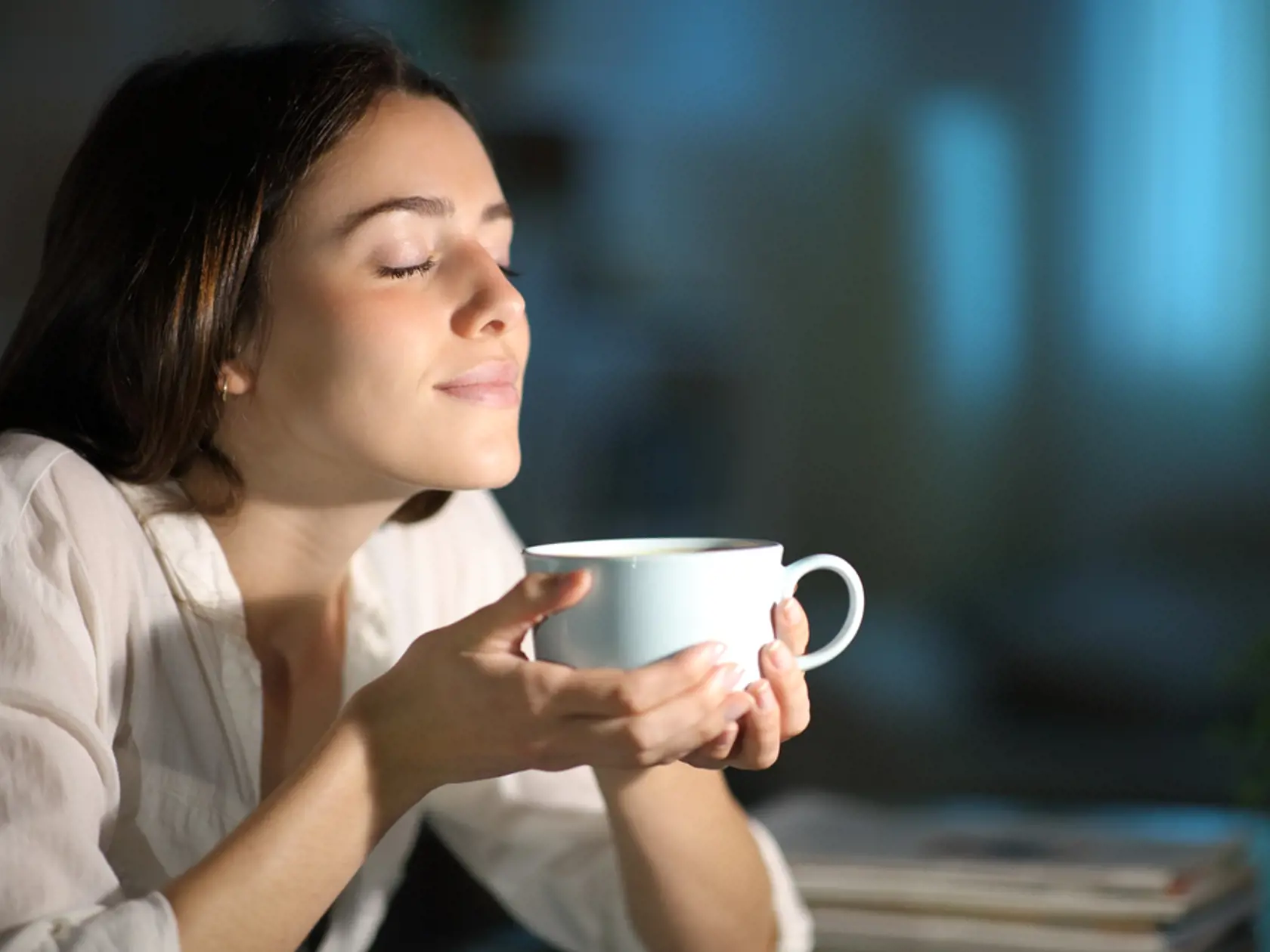 Relaxed,Woman,Smelling,Decaffeinated,Coffee,In,The,Night,At,Home