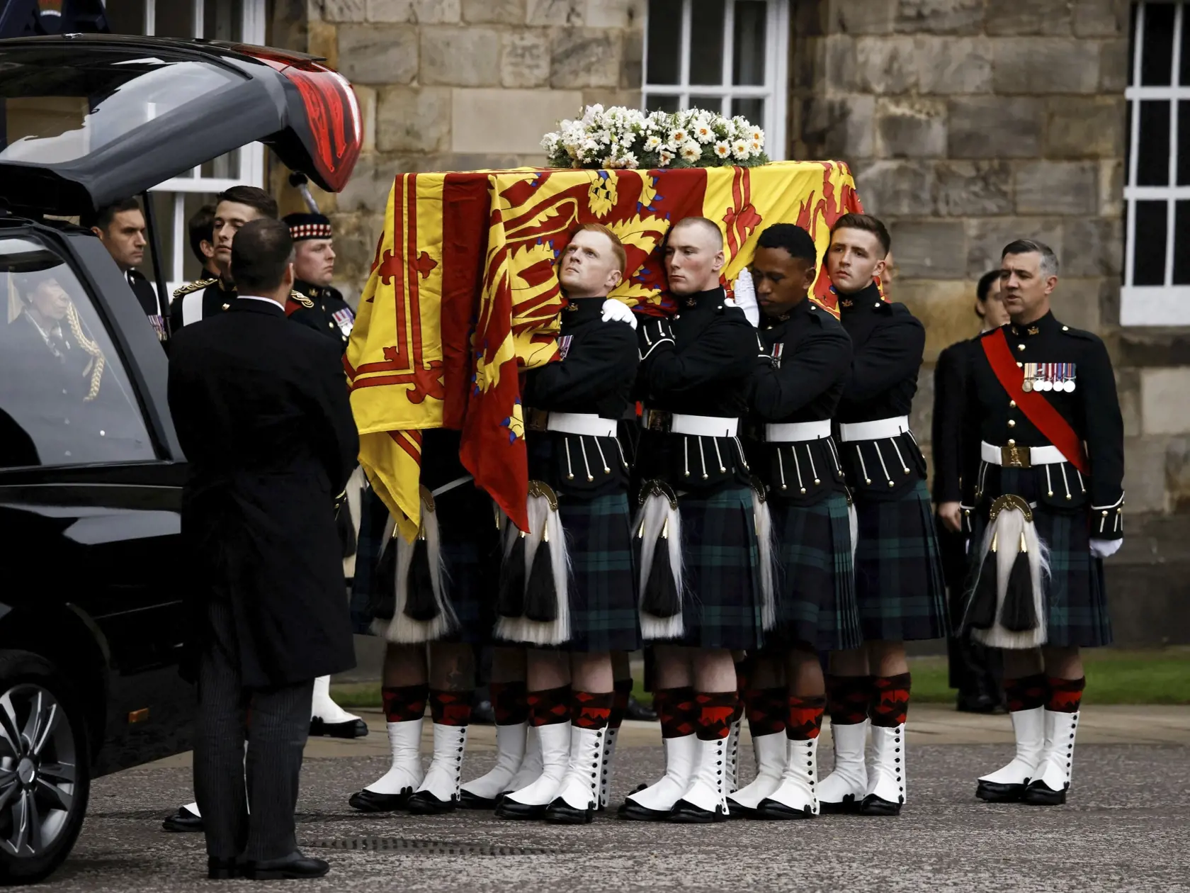 PK 104 Edinburgh - Na snímke nosiči rakvy s pozostatkami zosnulej britskej kráľovnej Alžbety II. ju nesú do zámku Holyrood v Edinburghu 11. septembra 2022. Rakva s pozostatkami zosnulej britskej kráľovnej Alžbety II. v nedeľu dorazila na zámok Holyrood v Edinburghu, ktorý je oficiálnym sídlom britského panovníka v Škótsku. Od štvrtka sa rakva nachádzala na Balmorale, kde sa s kráľovnou mohli rozlúčiť jej najbližší príbuzní. FOTO TASR/AP

Pallbearers carry the coffin of Queen Elizabeth II, draped