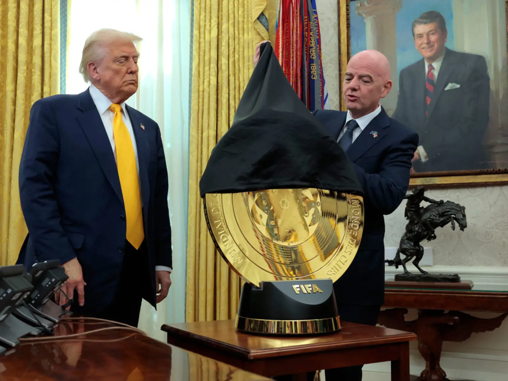 WASHINGTON, DC - MARCH 07: President of Fédération Internationale de Football Association (FIFA) Gianni Infantino (R) unveils the Club World Cup trophy alongside U.S. President Donald Trump in the Oval Office at the White House on March 07, 2025 in Washington, DC. President Trump signed an executive order establishing a White House Task Force for the 2026 World Cup.  (Photo by Anna Moneymaker/Getty Images)