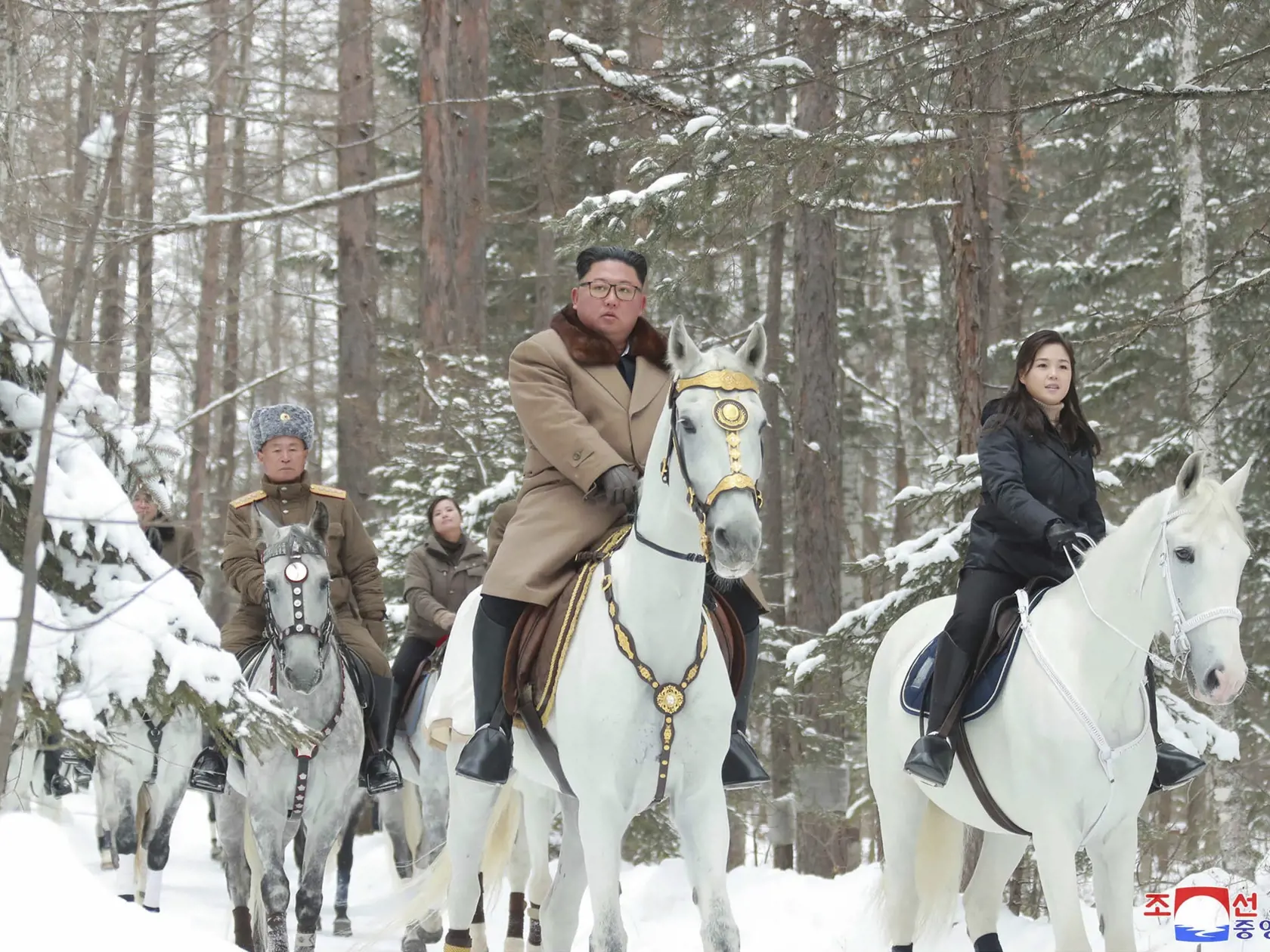 Na nedatovanej snímke, ktorú vydala 4. decembra 2019 severokórejská vláda, severokórejský líder Kim Čong-un (uprostred) a jeho manželka  Ri Sol-ču (vpravo) jazdia na bielych koňoch počas návštevy na posvätnej hore Pektu.
