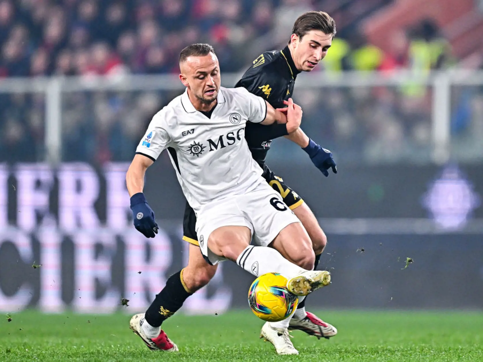 GENOA, ITALY - DECEMBER 21: Stanislav Lobotka of Napoli (left) and Fabio Miretti of Genoa vie for the ball during the Serie A match between Genoa and Napoli at Stadio Luigi Ferraris on December 21, 2024 in Genoa, Italy. (Photo by Simone Arveda/Getty Images)