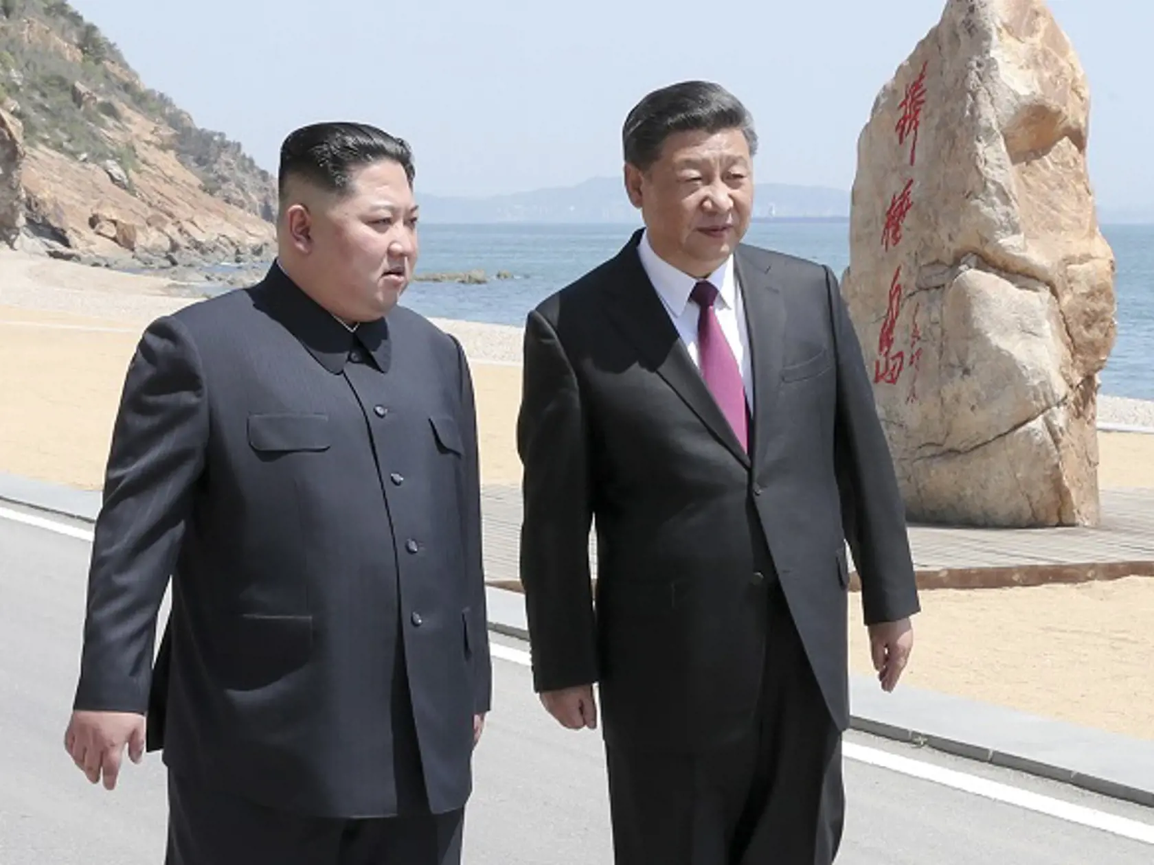 Na snímke zo 7. mája 2018 vpravo čínsky prezident Si Ťin-pching a vľavo severokórejský vodca Kim Čong-un počas rozhovoru na stretnutí v meste Dalian na severe Číny.