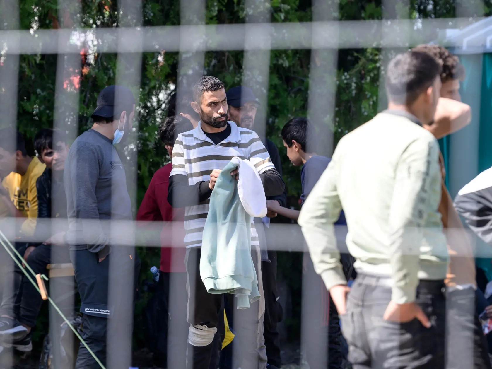 Na snímke nelegálni migranti, ktorí sú umiestnení v dočasnom pracovisku cudzineckej polície v priestoroch Okresného riaditeľstva Hasičského a záchranného zboru v Nových Zámkoch v utorok 5. septembra 2023. Migrantov sem presunuli z centra mesta. FOTO TASR - Henrich Mišovič 