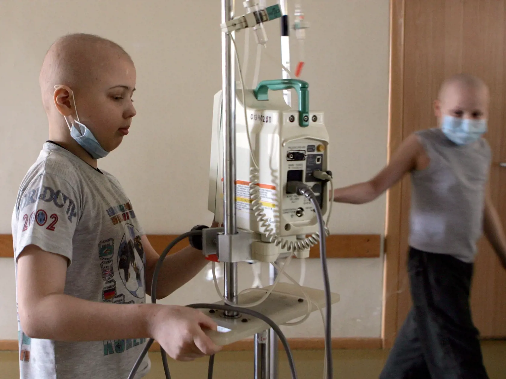 MINSK, BELARUS - MARCH 13:  Pasha (left) from the city of Baranovichi and Vova (right) Kazakhstan walk down the hallway of the Children's Oncology Center on March 13, 2006 in Minsk, Belarus. Both children have been diagnoised with lymphoma.  On April 26, 1986, reactor number four at the Chernobyl Nuclear Power Station on the border of the Ukraine and Belarus exploded. The fire, which burned out of control for five days, spewed more than 50 tons of radioactive fallout across Belarus. The wind car