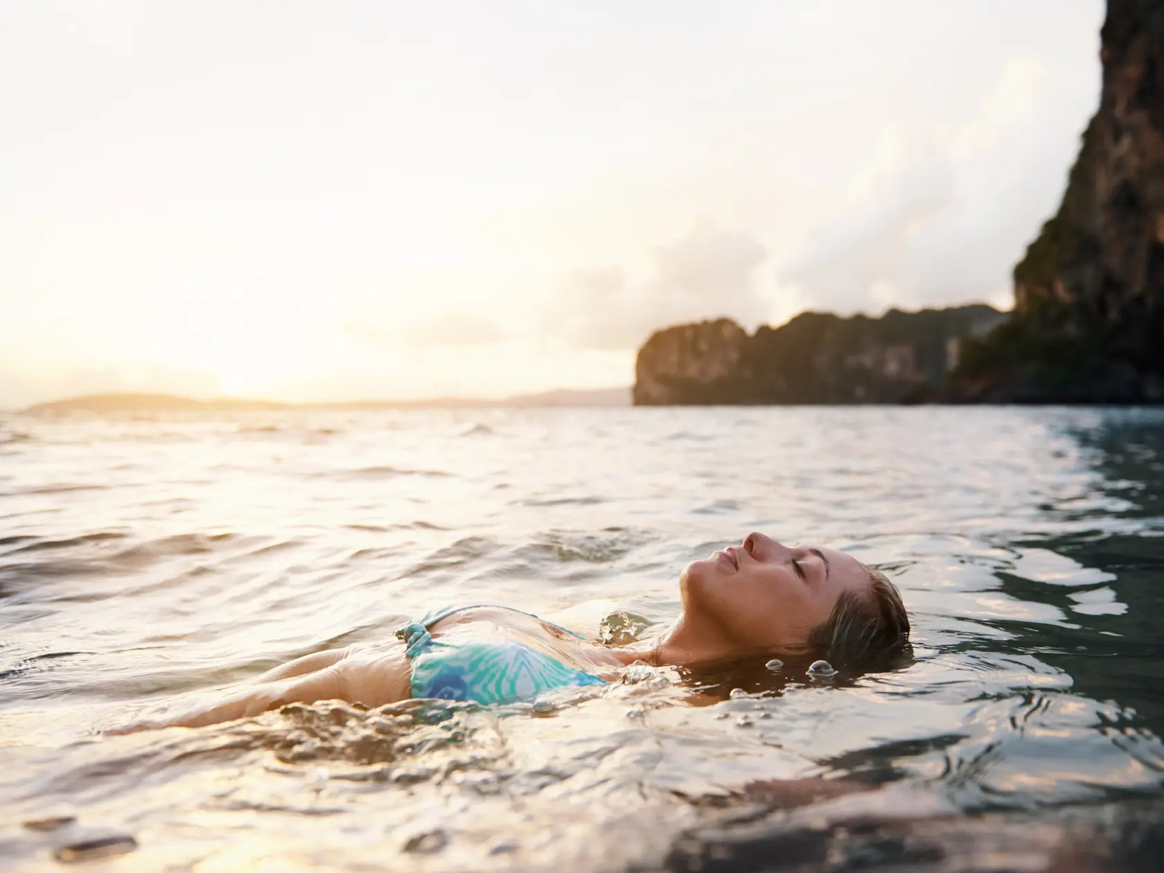 Shot of a woman floating on her back in the ocean