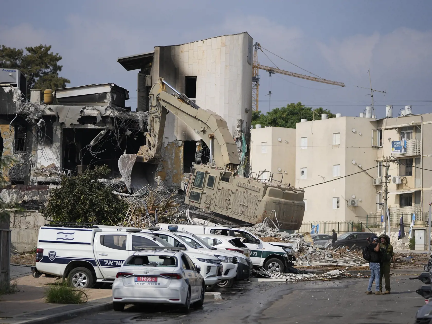 JB 49 Sderot - Báger odpratáva trosky zo zničenej policajnej stanice, ktorej sa v sobotu zmocnili militanti Hamasu v meste Sderot na juhu Izraela 8. októbra 2023. Izraelský bezpečnostný kabinet vyhlasuje vojnový stav v reakcii na sobotňajšie útoky palestínskeho hnutia Hamas. Oznámila to v nedeľu kancelária izraelského premiéra Benjamina Netanjahua. TASR o tom informuje na základe správy agentúry DPA. Tento krok umožní uskutočniť rozsiahle vojenské kroky. Vojna voči Izraelu bola podľa vyjadrení p