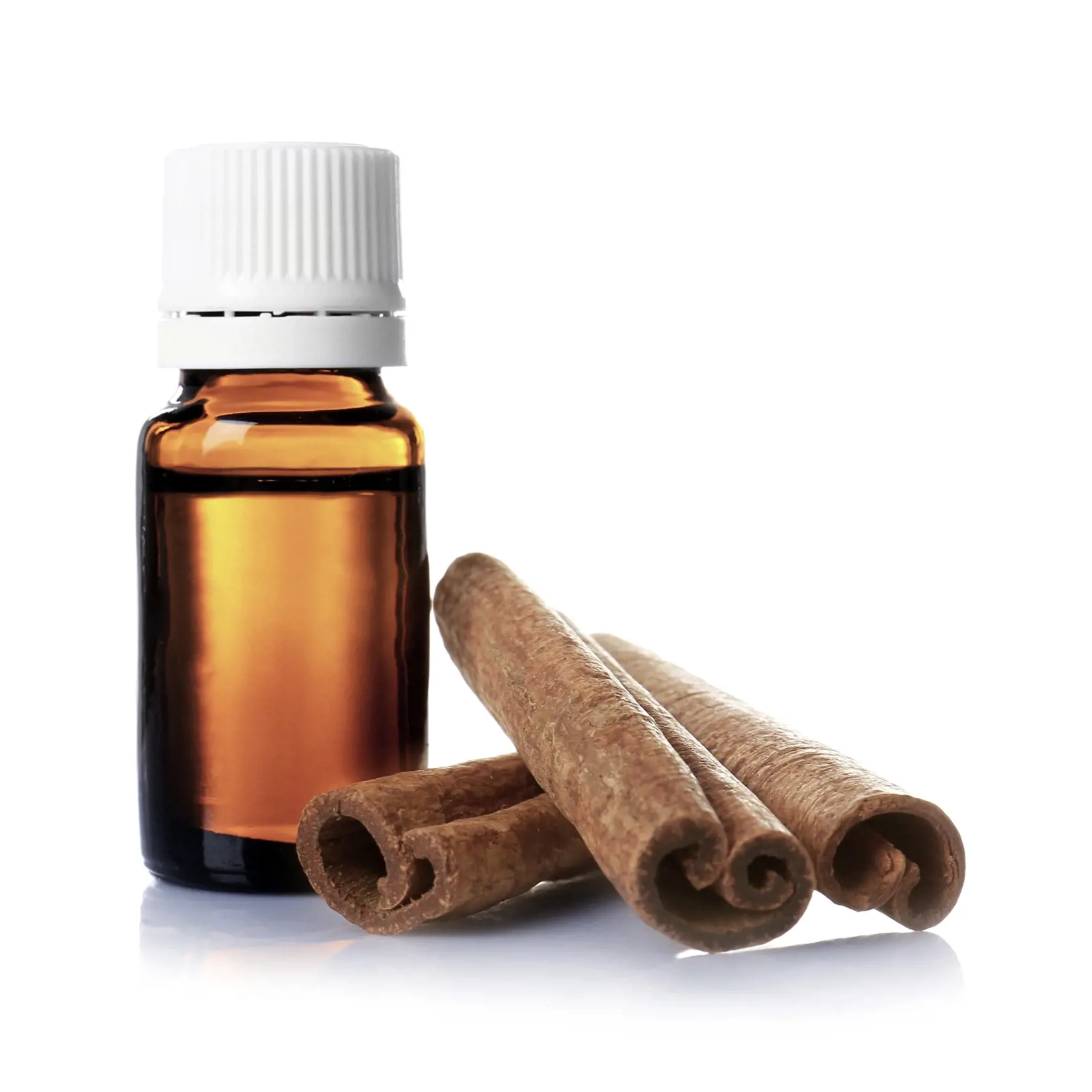 Glass bottle with essential cinnamon oil and sticks on white background