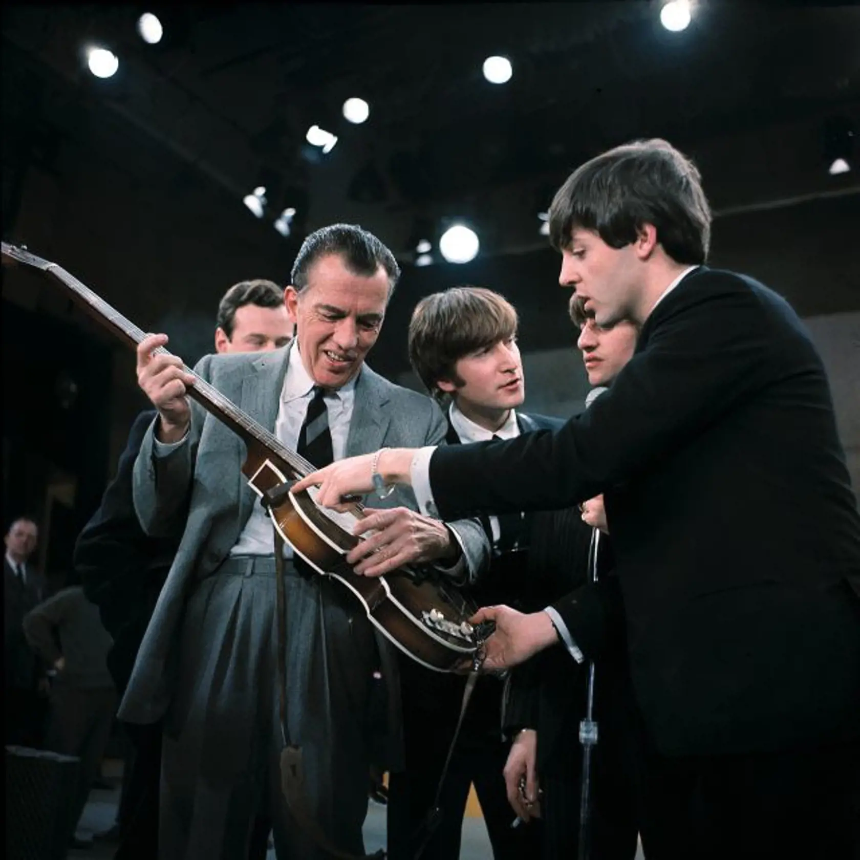 FILE - In this Feb. 9, 1964. file photo Paul McCartney, right, shows his bass guitar to Ed Sullivan before the Beatles' live television appearance on "The Ed Sullivan Show" in New York along with John Lennon, center, and Ringo Starr, behind McCartney, and Beatles manage Brian Epstein, behind Sullivan. McCartney turned 70 Monday June 18, 2012. (AP Photo)