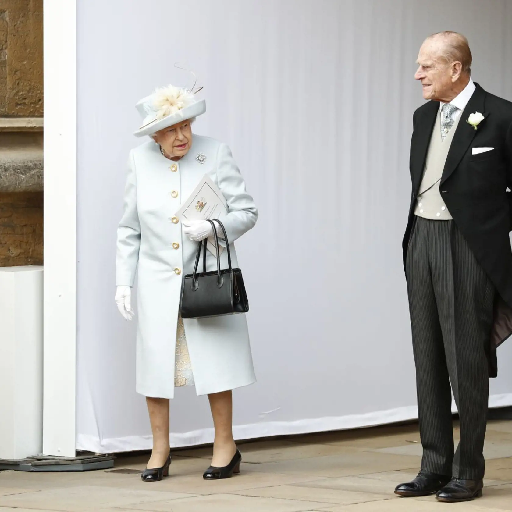 Britain's Queen Elizabeth II, and Prince Philip wait for the arrival by open carriage of Princess Eugenie of York and Jack Brooksbank following their wedding in St George's Chapel, Windsor Castle, near London, England, Friday, Oct. 12, 2018. (AP Photo/Alastair Grant, Pool)