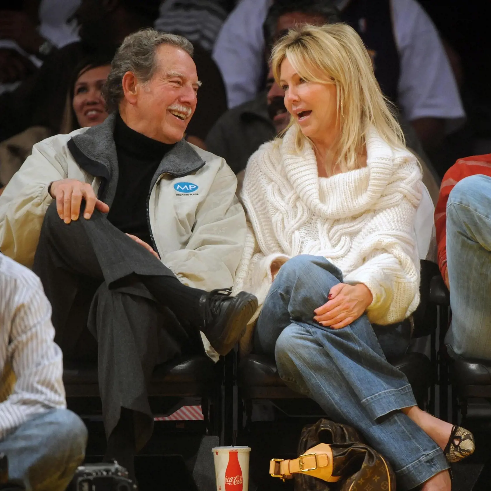 ©2009 GAMEPIKS PHOTO Actress Heather Locklear and her "Melrose Place" cast mate Thomas Calabro (R) share a laugh as her father Bill (L) sits courtside as they attend the Los Angeles Lakers/New Jersey Nets NBA game at Staples Center in Los Angeles on November 29, 2009. The Lakers defeated the Nets 106-87. XYZ (Photo by Philip Ramey/Corbis via Getty Images)