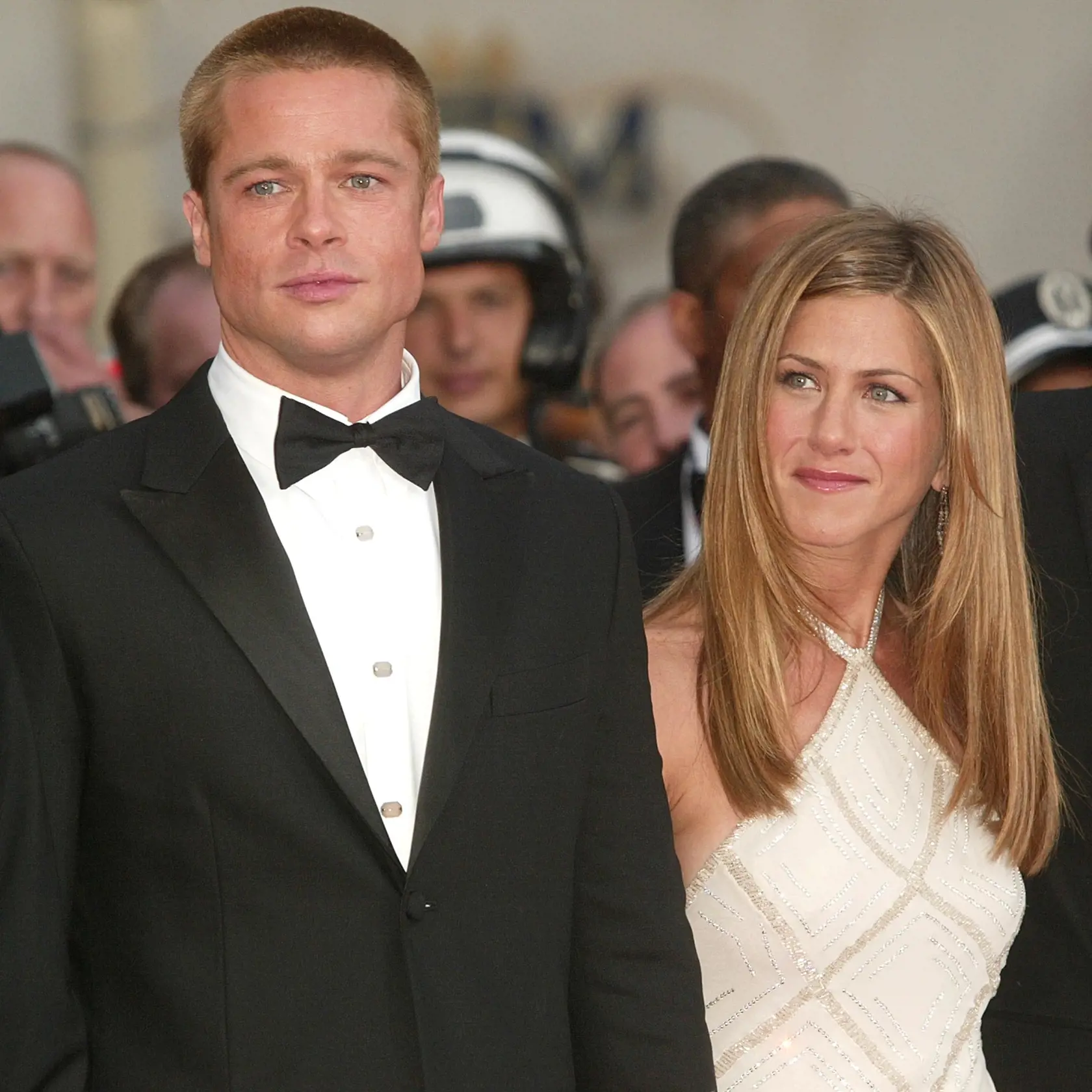 CANNES, FRANCE - MAY 13:  Actor Brad Pitt and wife actress Jennifer Aniston attend the World Premiere of the epic movie "Troy" at Le Palais de Festival on May 13, 2004 in Cannes, France. Aniston wears a dress by Versace. (Photo by Evan Agostini/Getty Images)

