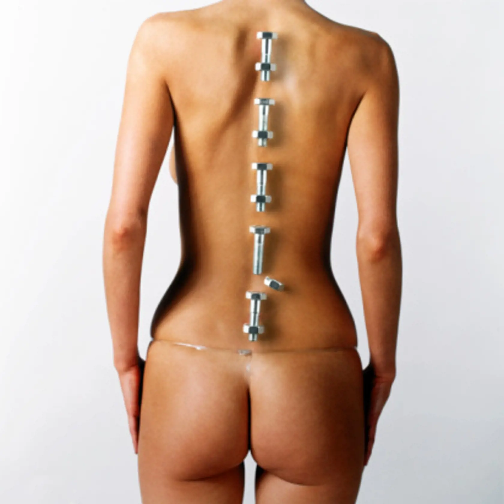 Woman with bolts placed over line of backbone, one nut out of place