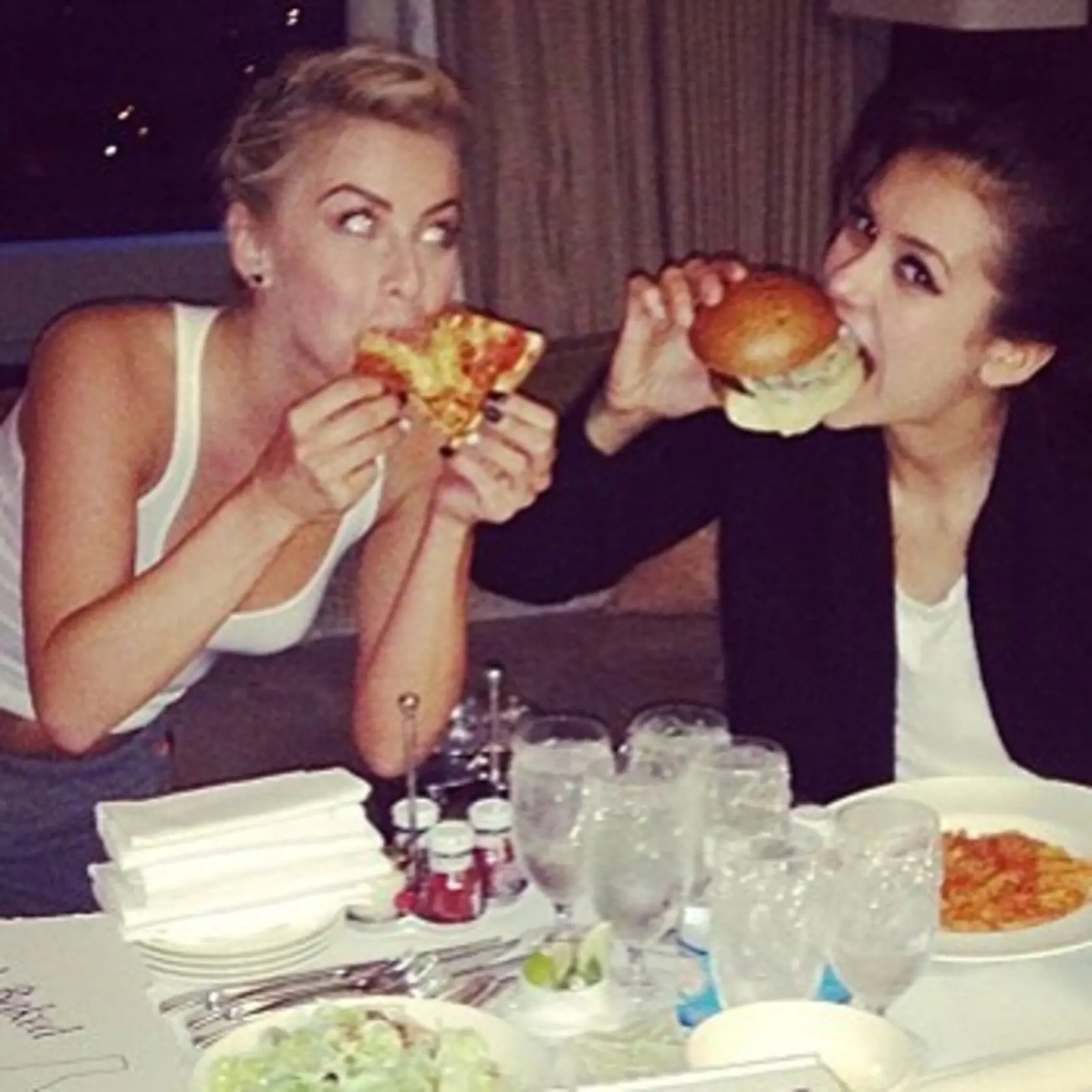 Julianne Hough "I'm assuming that everyone's favorite thing about Chicago is the deep dish, right? I know I'll be craving it when I get home from the tour, so I jotted down this recipe for all of us. If you get to make it before me, take a pic and tag me! Recipe link in profile. In the meantime, here is a little pic of me and my #mondaymuse @ninadobrev yeah she's got a burger but I've got the pizza!", Image: 253999864, License: Rights-managed, Restrictions: , Model Release: no, Credit line: Prof