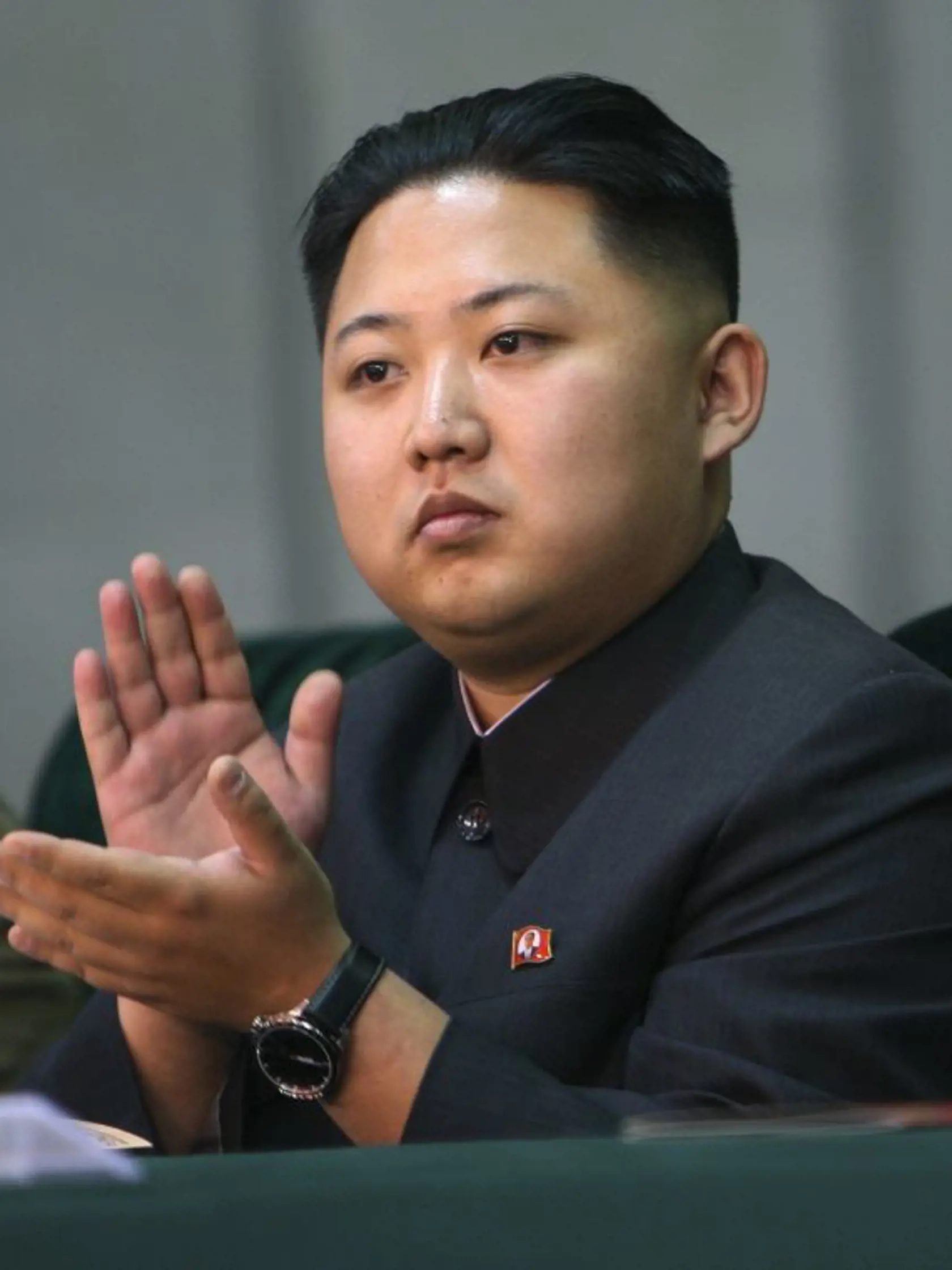 FILE - In this Oct. 9, 2010 file photo released by China's Xinhua News Agency, Kim Jong Un, the third son of North Korean leader Kim Jong Il, applauds while watching the Arirang mass games performance staged to celebrate the 65th anniversary of the founding of the Workers' Party of Korea, in Pyongyang, North Korea. North Korean state media announced Kim Jong Il's death on Monday, Dec. 19, 2011. (AP Photo/Xinhua, Yao Dawei) NO SALES