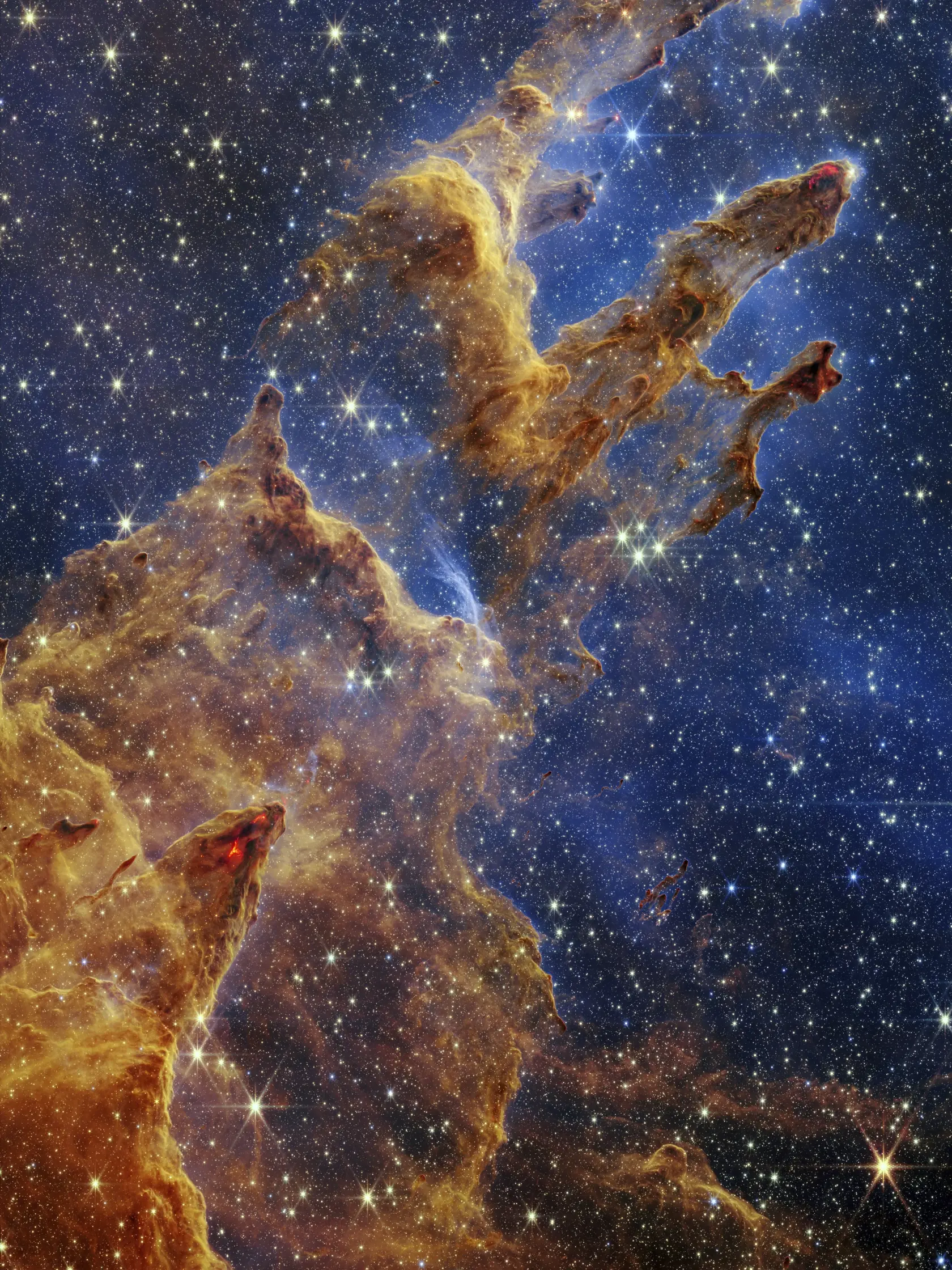Na snímke poskytnutej americkým Národným úradom pre letectvo a vesmír (NASA) 19. októbra 2022 sú Stĺpy stvorenia ako súčasť Orlej hmloviny zachytené vesmírnym teleskopom Jamesa Webba v takmer infračervenom svetle.