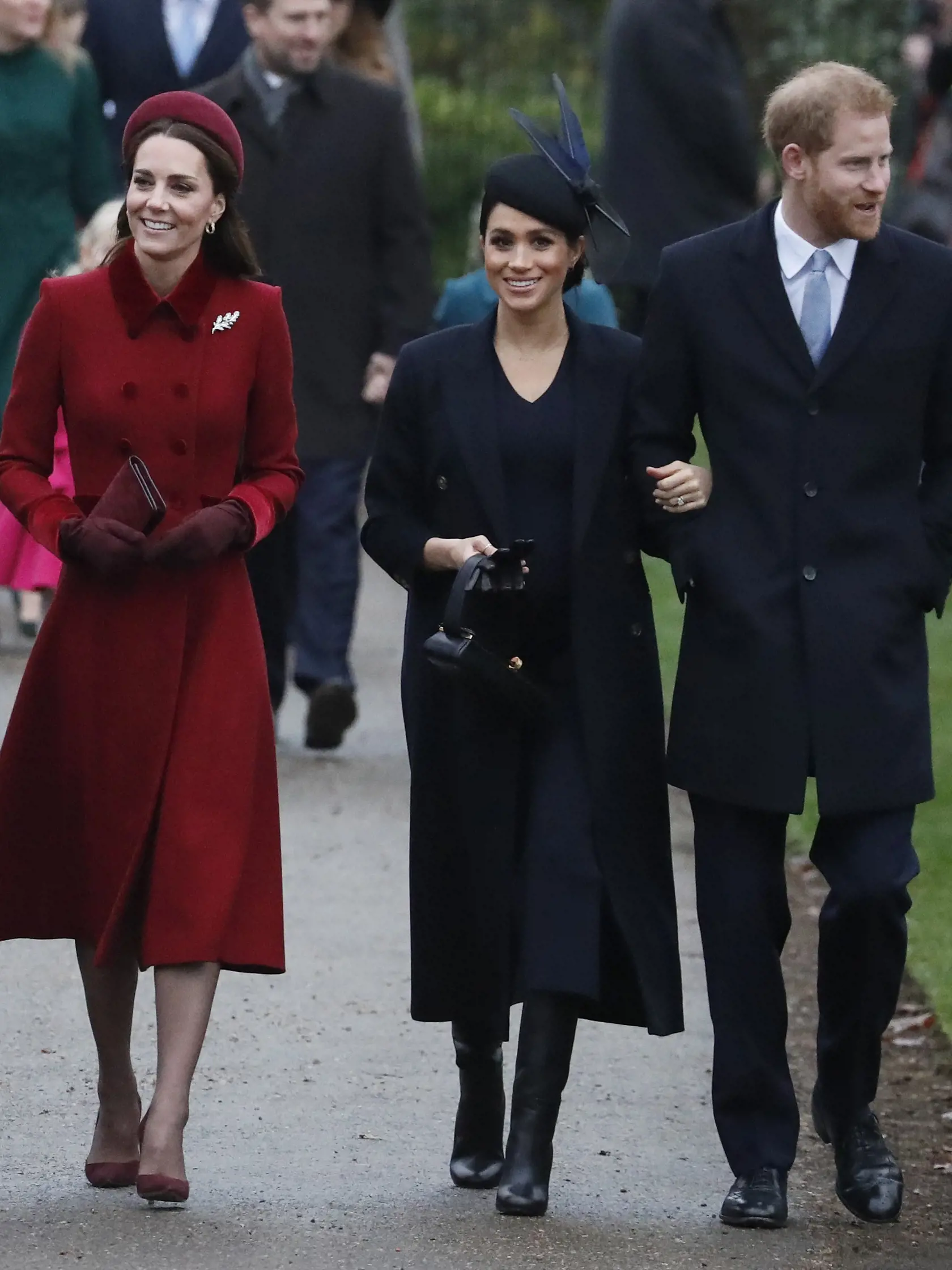 Britain's Kate, Duchess of Cambridge, left, Meghan Duchess of Sussex and Prince Harry, right, arrive to attend the Christmas day service at St Mary Magdalene Church in Sandringham in Norfolk, England, Tuesday, Dec. 25, 2018. (AP PhotoFrank Augstein)
