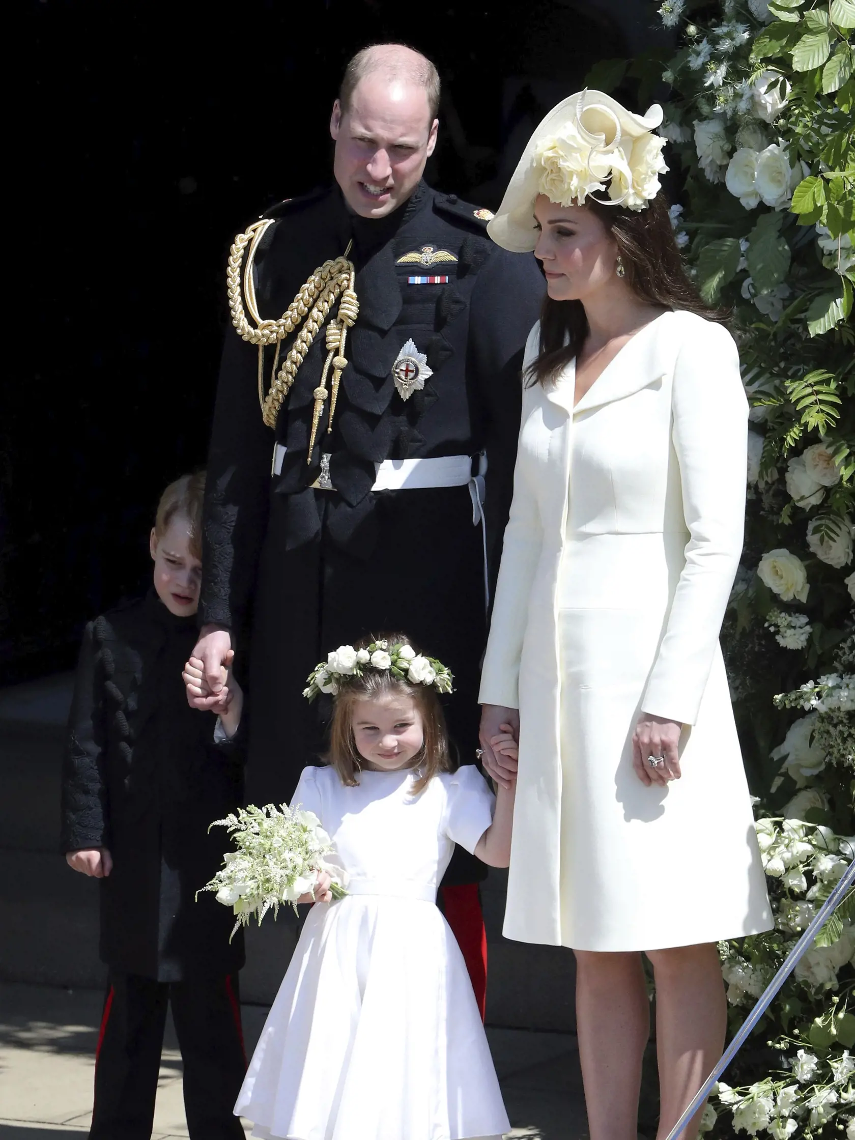 Britain's Prince William and Kate, Duchess of Cambridge with Prince George and Princess Charlotte leave after the wedding ceremony of Prince Harry and Meghan Markle at St. George's Chapel in Windsor Castle in Windsor, near London, England, Saturday, May 19, 2018. (Andrew Matthews/pool photo via AP)