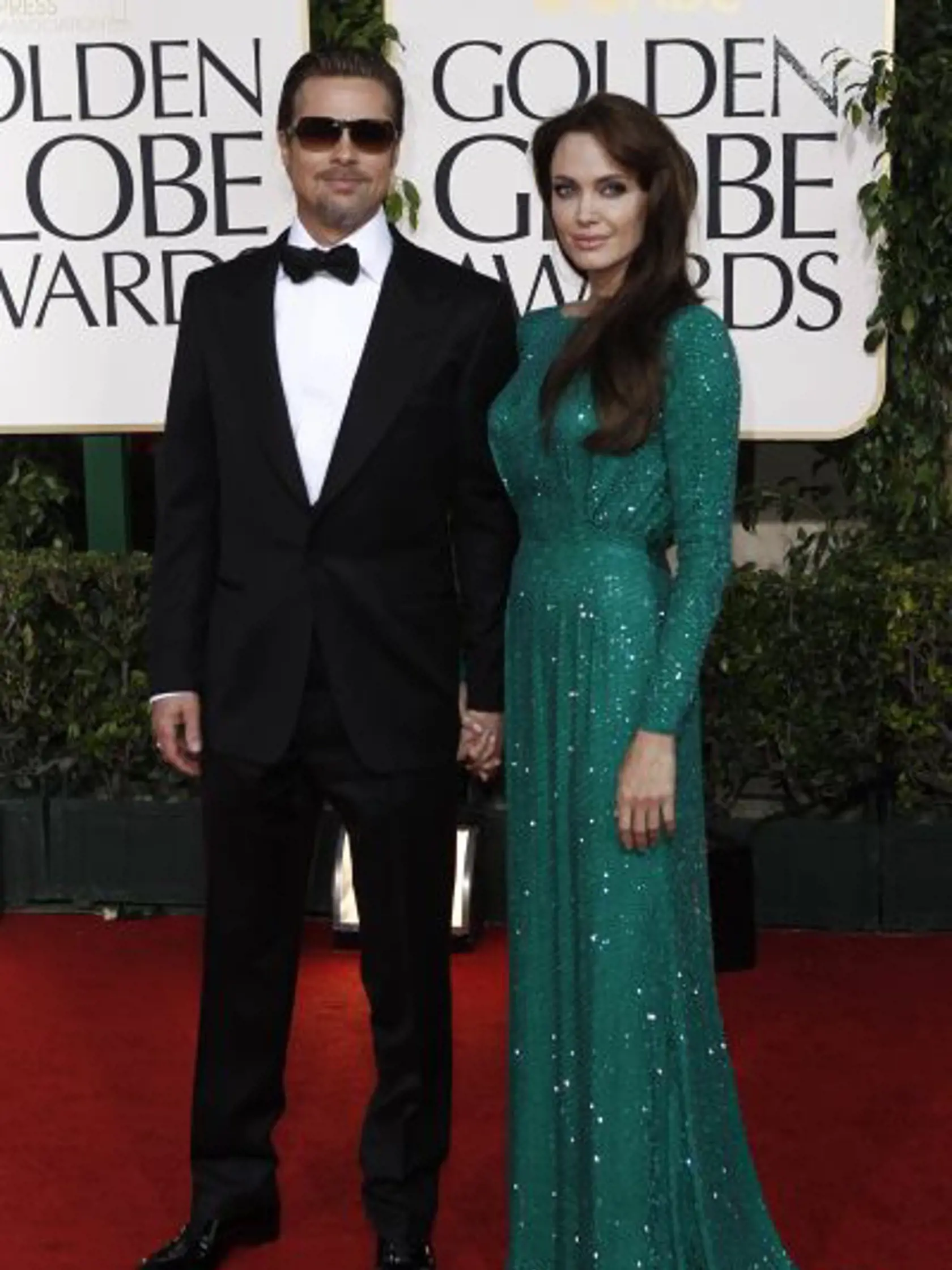 Angelina Jolie and Brad Pitt, left, arrive for the Golden Globe Awards Sunday, Jan. 16, 2011, in Beverly Hills, Calif. (AP Photo/Matt Sayles)