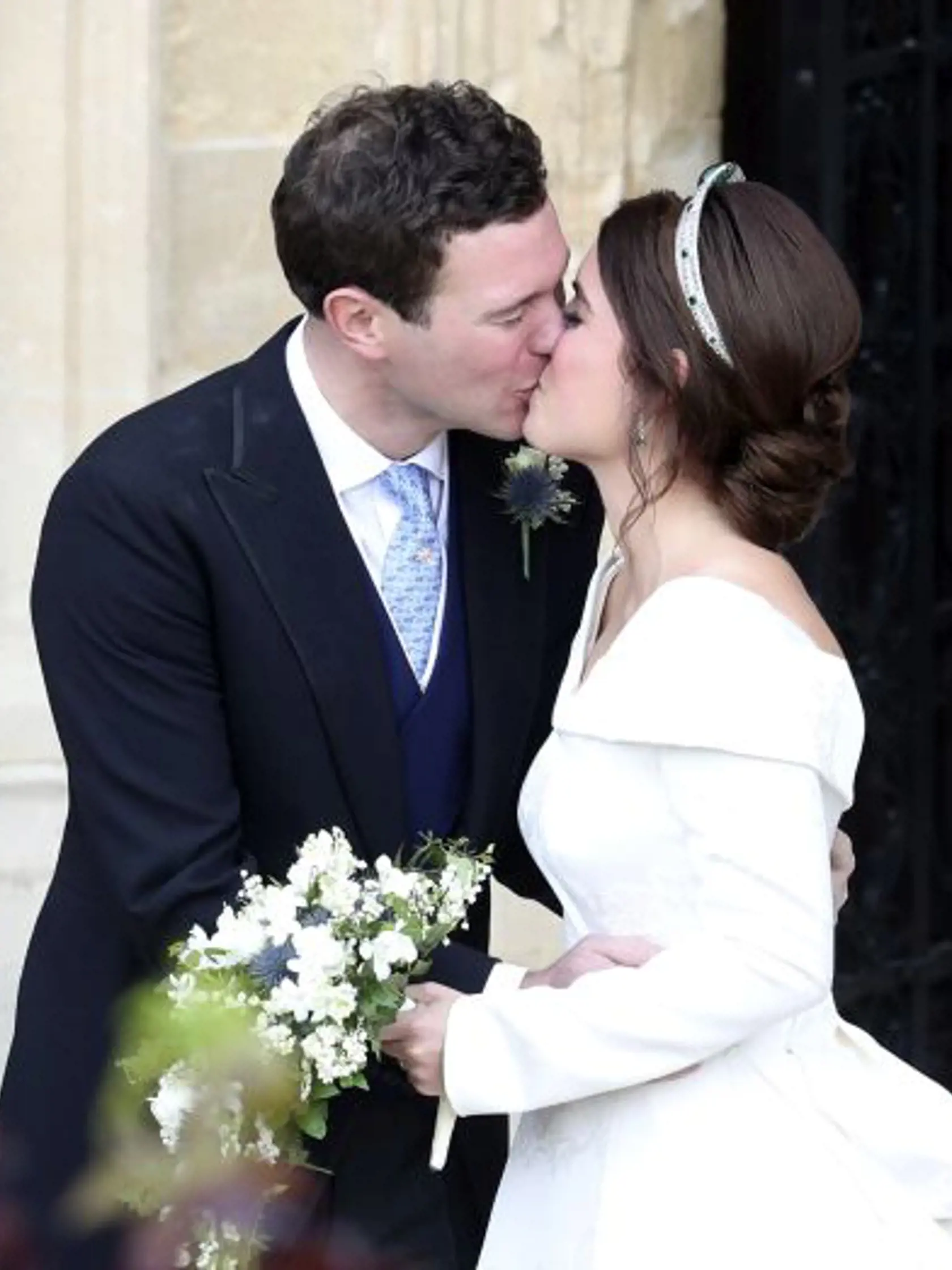 Princess Eugenie and her new husband Jack Brooksbank kiss after their wedding ceremony as they leave St George's Chapel, Windsor Castle, near London, England, Friday Oct. 12, 2018. (Andrew Matthews, Pool via AP)