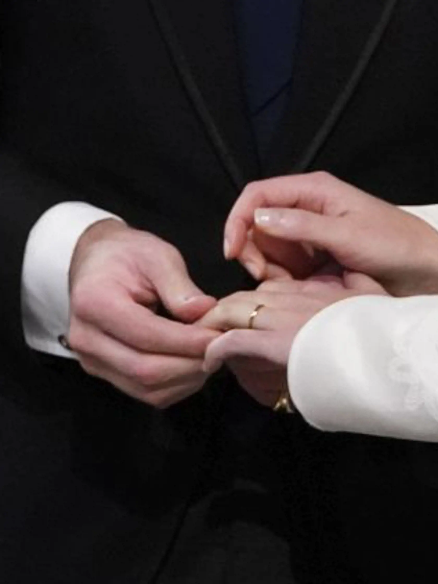 Jack Brooksbank places the ring on the finger of his bride Princess Eugenie during their wedding ceremony in St Georgeâs Chapel, Windsor Castle, near London, England, Friday Oct. 12, 2018. (Danny Lawson/Pool via AP)