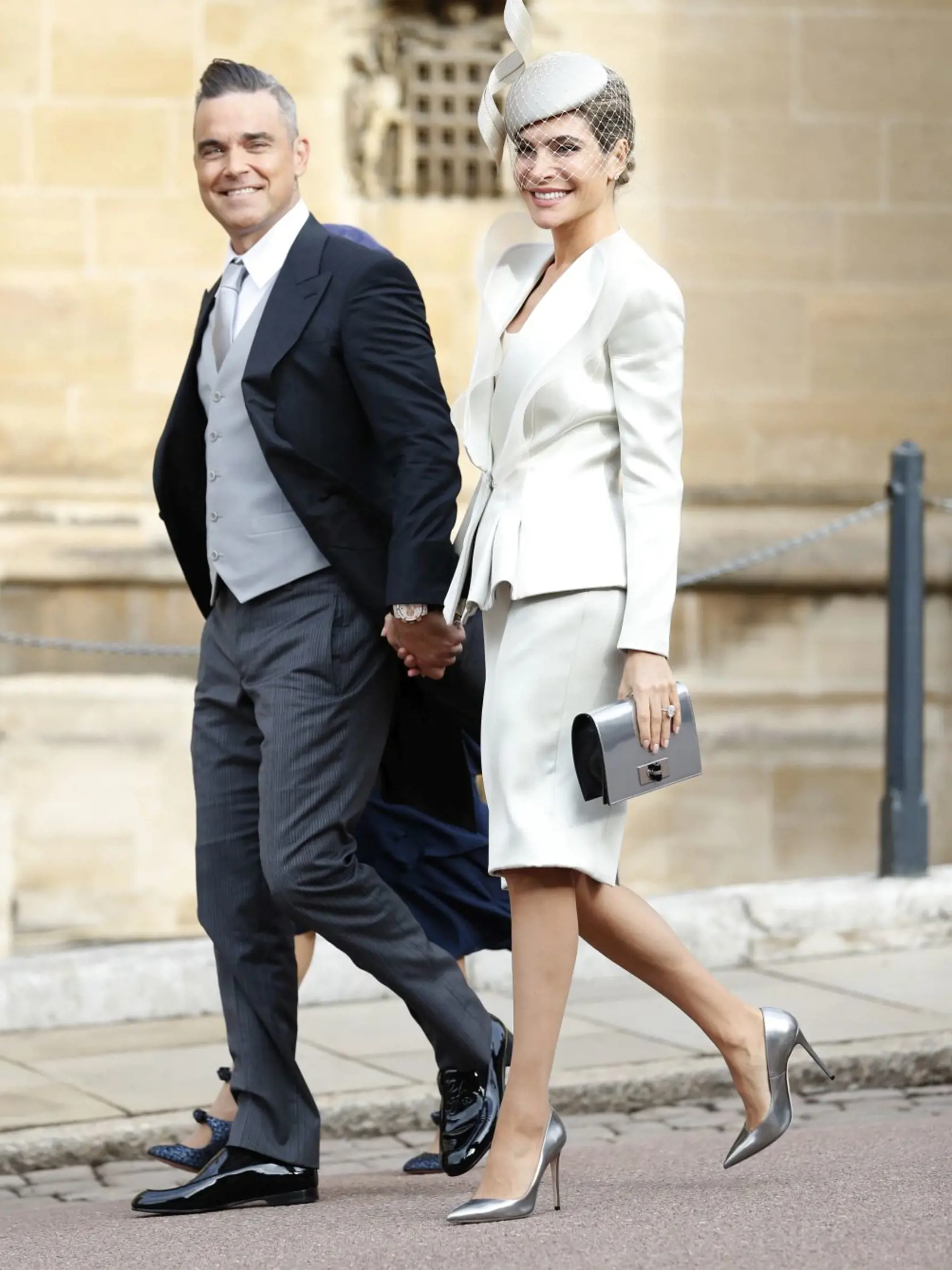 British singer Robbie Williams and his wife Ayda Field, right, arrive for the wedding of Princess Eugenie of York and Jack Brooksbank at St George's Chapel, Windsor Castle, near London, England, Friday, Oct. 12, 2018. (AP Photo/Alastair Grant, Pool)