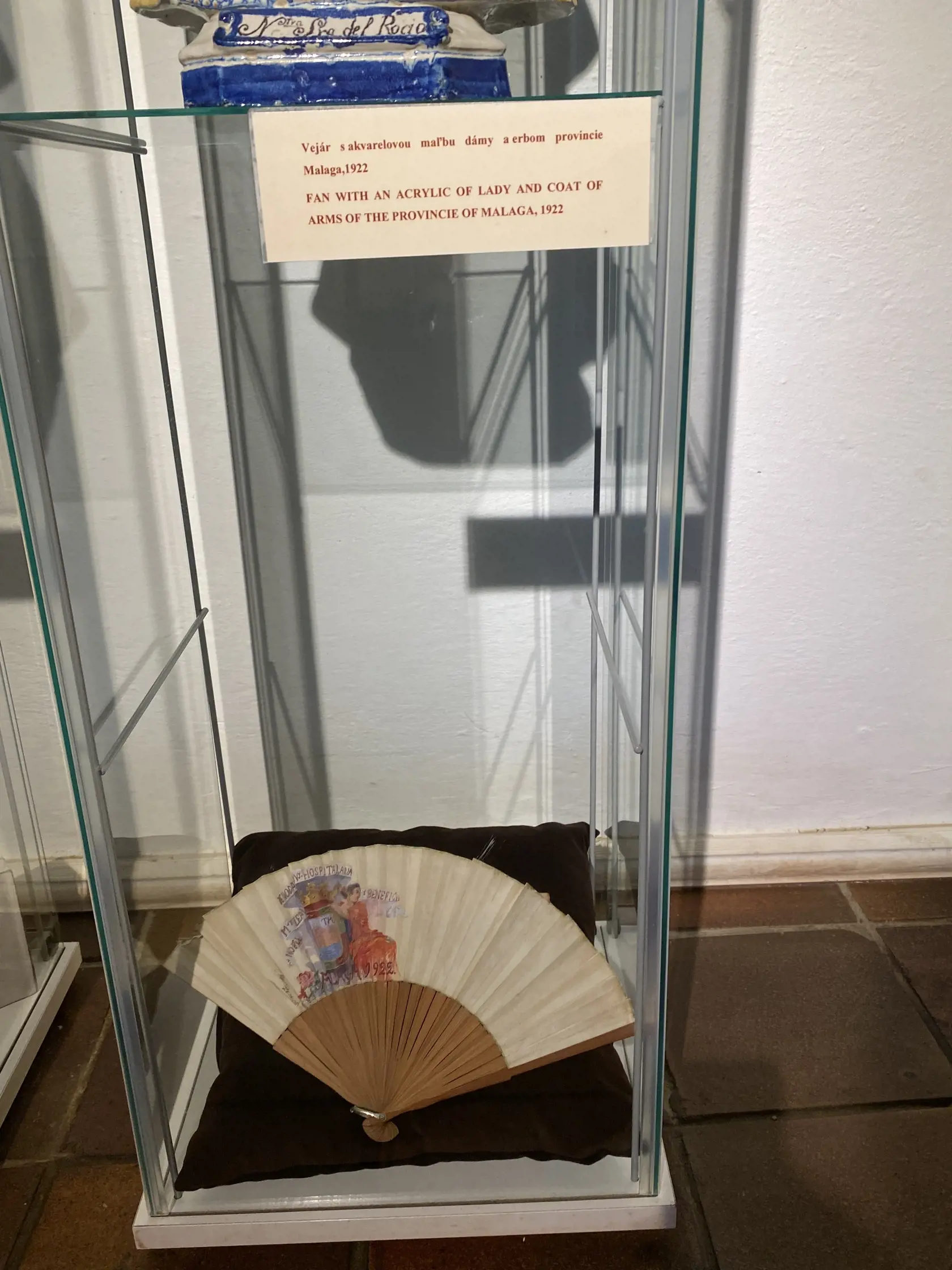 Ozdobný predmet z bývania princezien na Ľubovnianskom hrade - vejár s akvarelovou maľbou dámy s erbom provincie Malaga z roku 1922.