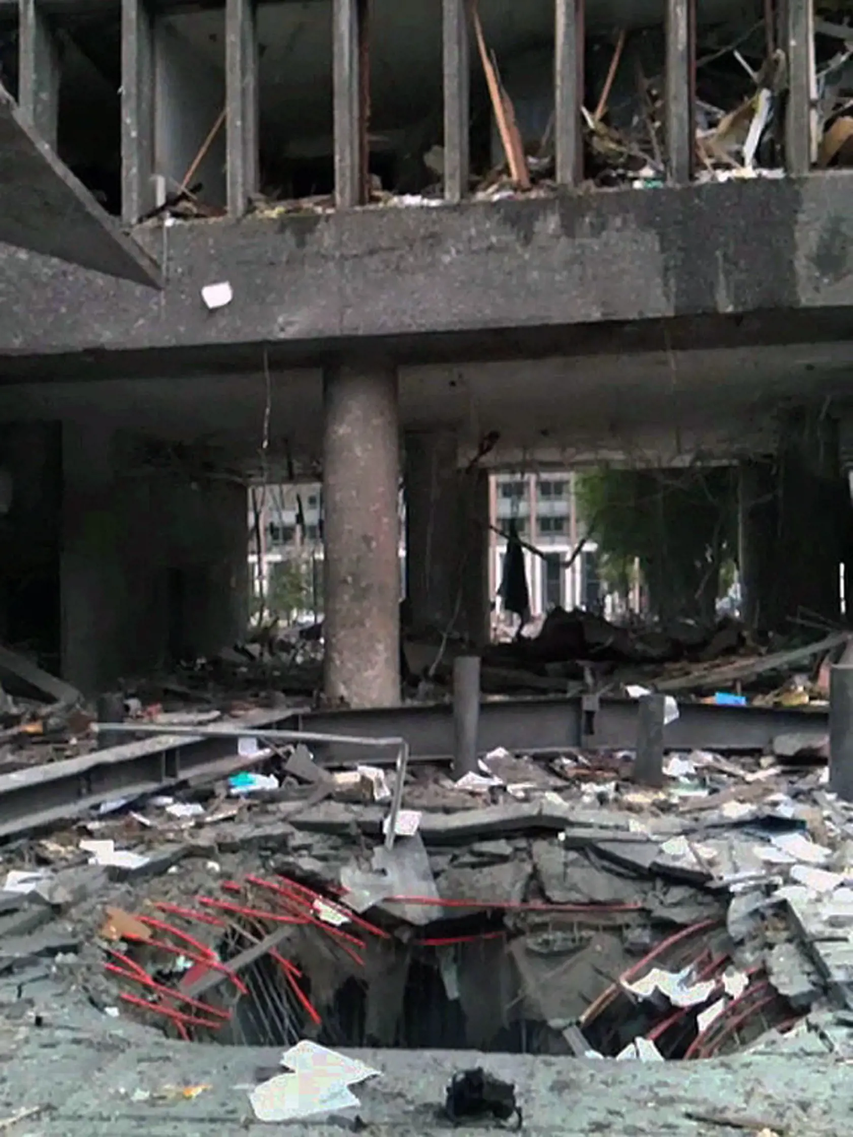 This video image released Thursday July 28, 2011 was taken minutes after the explosion Friday July 22, 2011 outside the Norwegian government office building in Oslo and shows the crater in the ground after the car bomb exploded at approximately 1522 hours local time. Nearly a week after the twin terror attacks that killed 76 in Norway, investigators are finding little evidence to support the attacker, Anders Behring Breivik, claims that he belongs to an underground militant network with cells ar