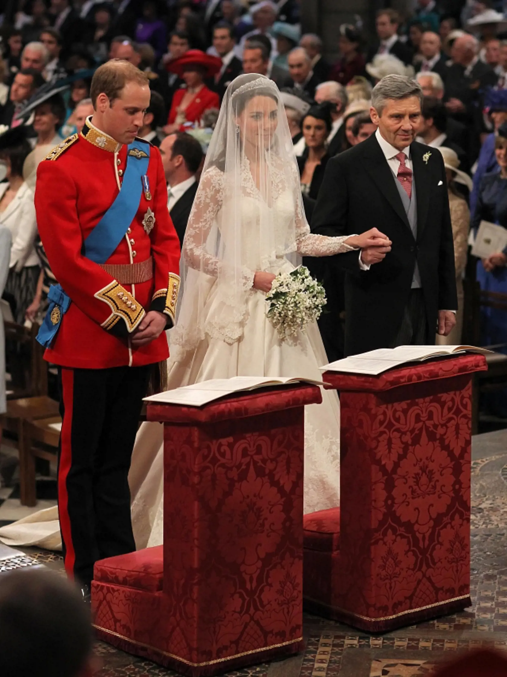 Prince William and Kate Middleton stand at the altar with Kate's father Michael Middleton inside Westminster Abbey where the couple will marry Friday April, 29, 2011. (AP Photo/Dominic Lipinski/Pool)