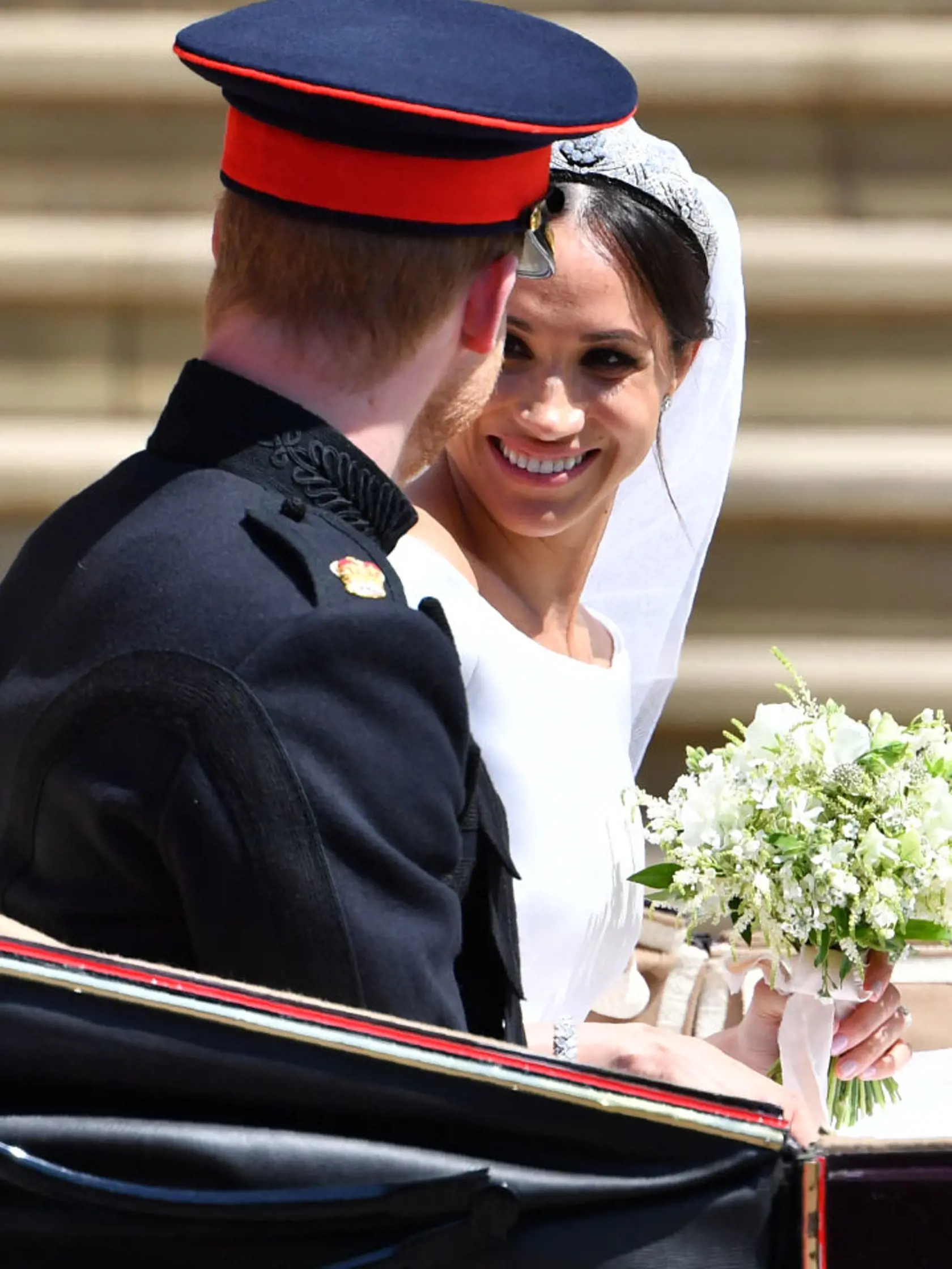 WINDSOR, UNITED KINGDOM - MAY 19: Prince Harry, Duke of Sussex and the Duchess of Sussex get into the Ascot Landau Carriage after their wedding ceremony at St George's Chapel, Windsor Castle on May 19, 2018 in Windsor, England. (Photo by  Ben STANSALL - WPA Pool/Getty Images)