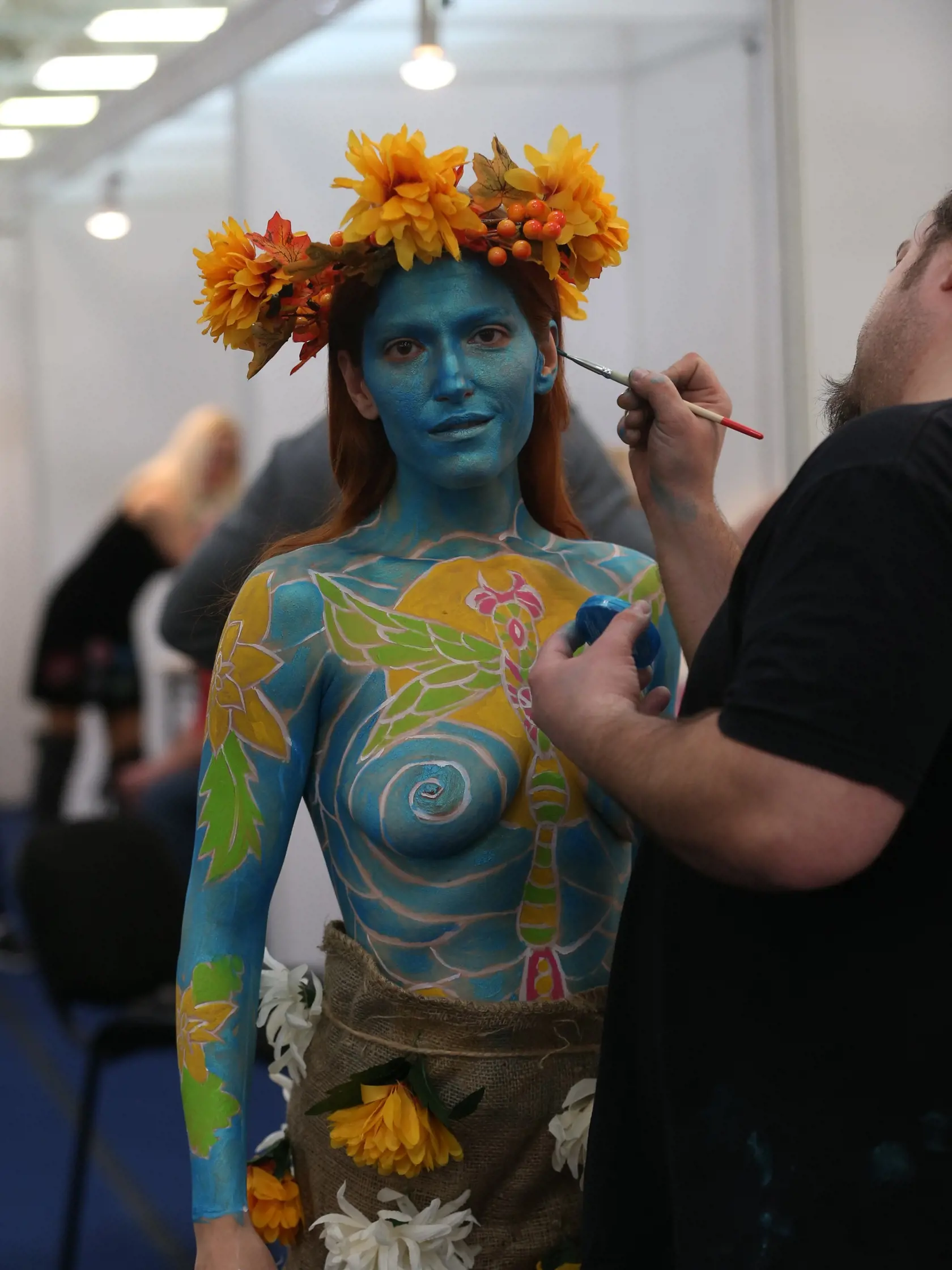 Bodypainter sa Interbeauty v Inchebe robí posledné úpravy modelky.