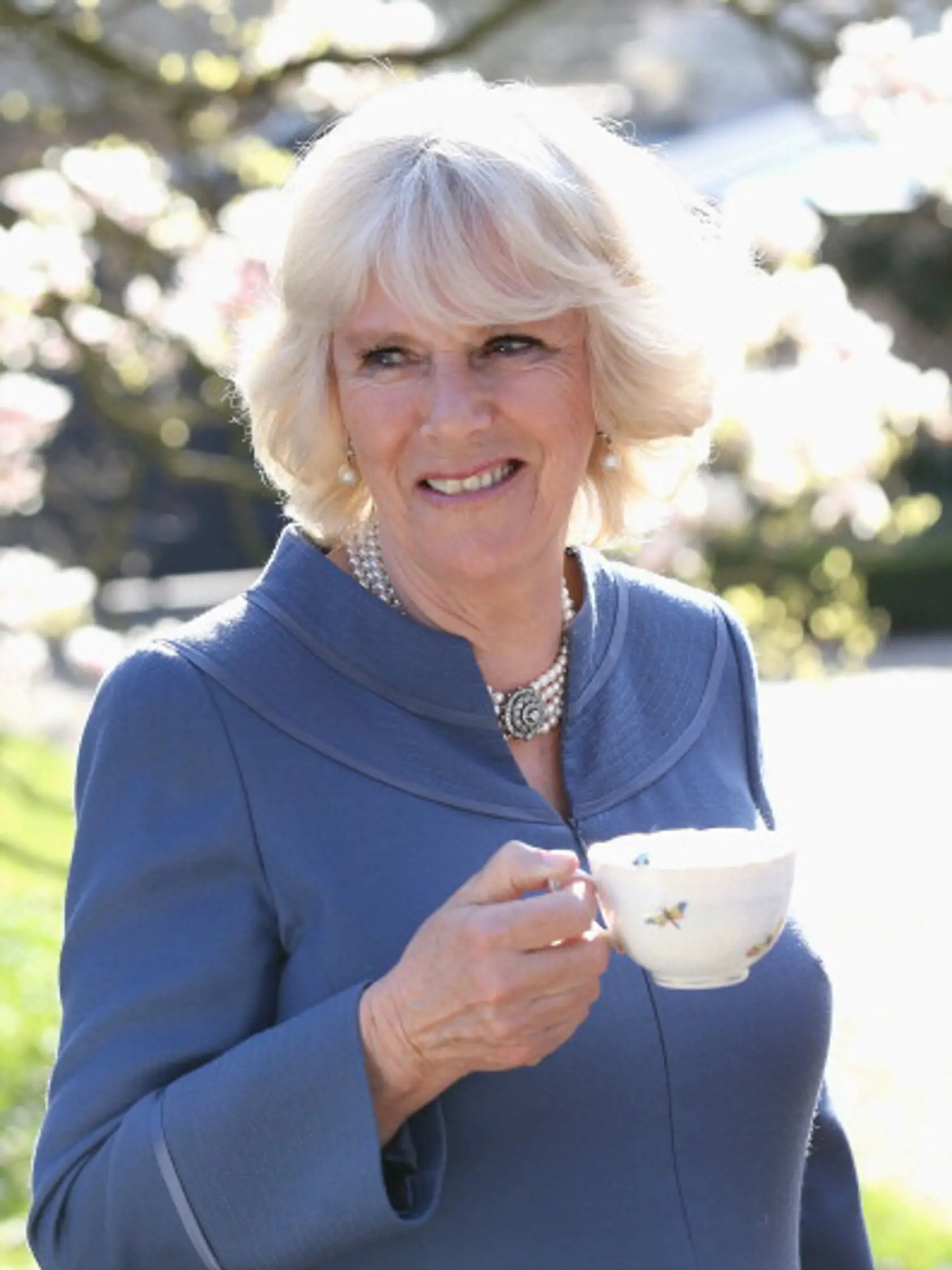 LONDON, ENGLAND - APRIL 23:  Camilla, Duchess of Cornwall drinks a cup of tea in Clarence House garden as she hosts a tea party to celebrate the 5th Anniversary of the charity 'First Story' on April 23, 2013 in London, England. First Story strives to support and inspire creativity in challenging UK secondary schools and their communities. The charity was launched in 2008 by former school teacher Katie Waldegrave.  (Photo by Chris Jackson- WPA Pool/Getty Images)