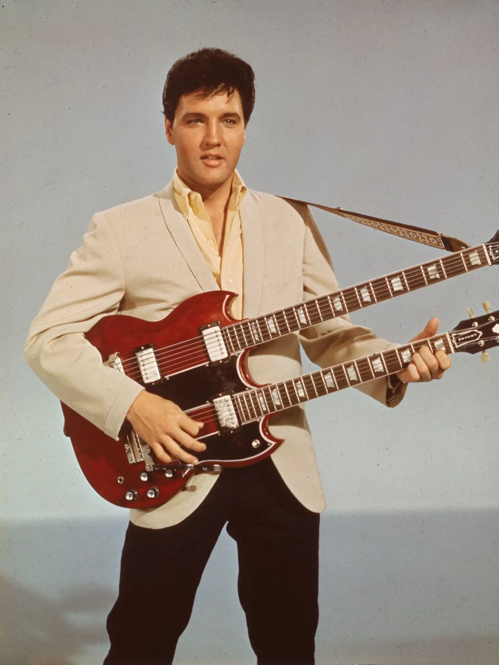 Portrait of American singer and actor Elvis Presley (1935 - 1977) as he holds a twelve string guitar, mid 1950s . (Photo by Hulton Archive/Getty Images)