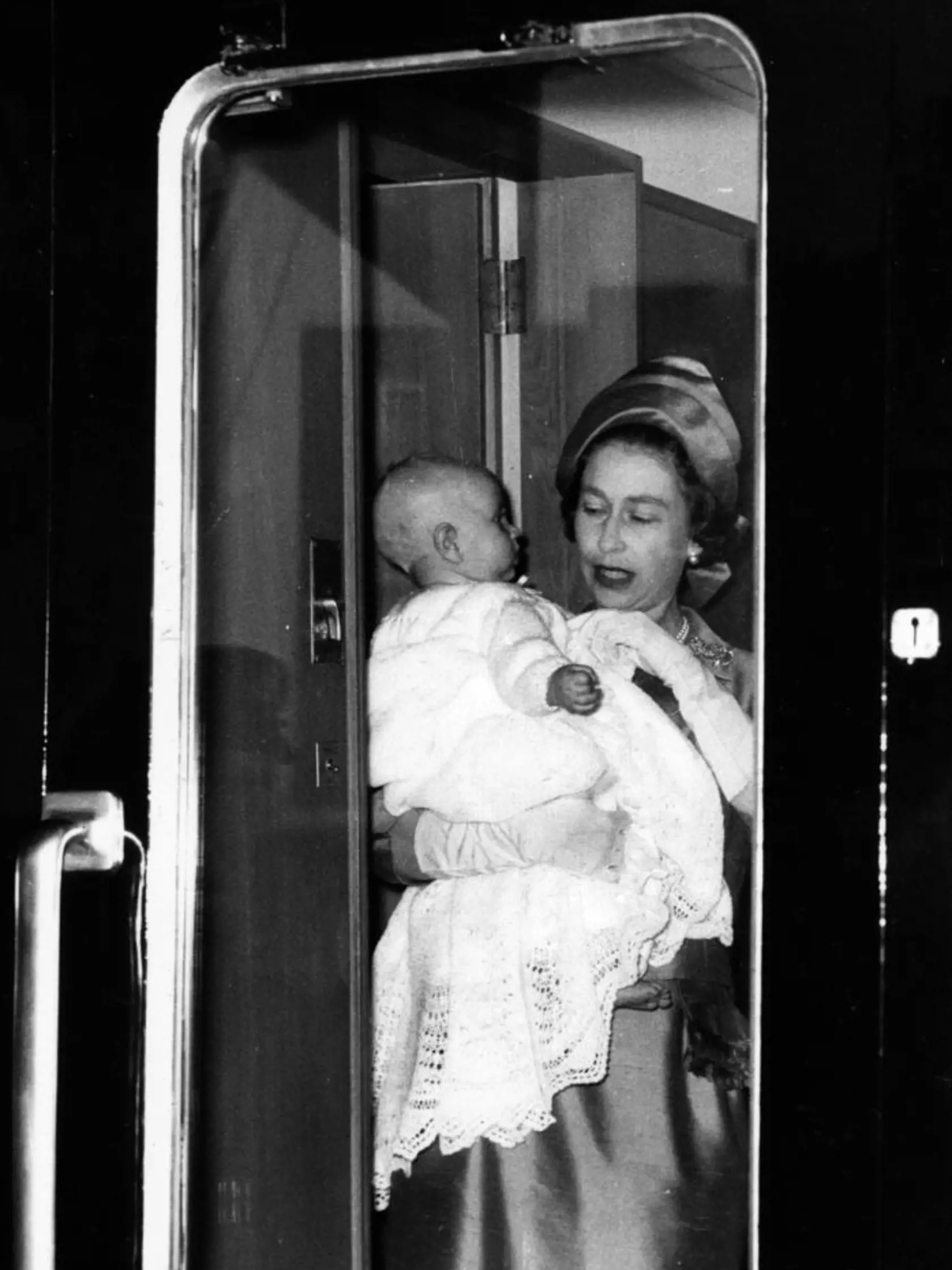 11th June 1964:  Queen Elizabeth II holding Prince Edward on their way to Balmoral Castle in Scotland.  (Photo by Roger Jackson/Central Press/Getty Images)