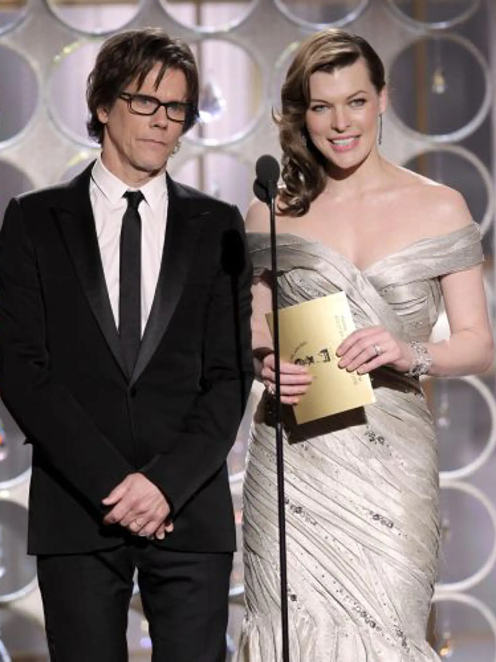 In this publicity image released by NBC,  presenters Kevin Bacon, left, and Milla Jovovich are shown during the Golden Globe Awards, Sunday, Jan. 16, 2011 in Beverly Hills, Calif. (AP Photo/NBC, Paul Drinkwater)