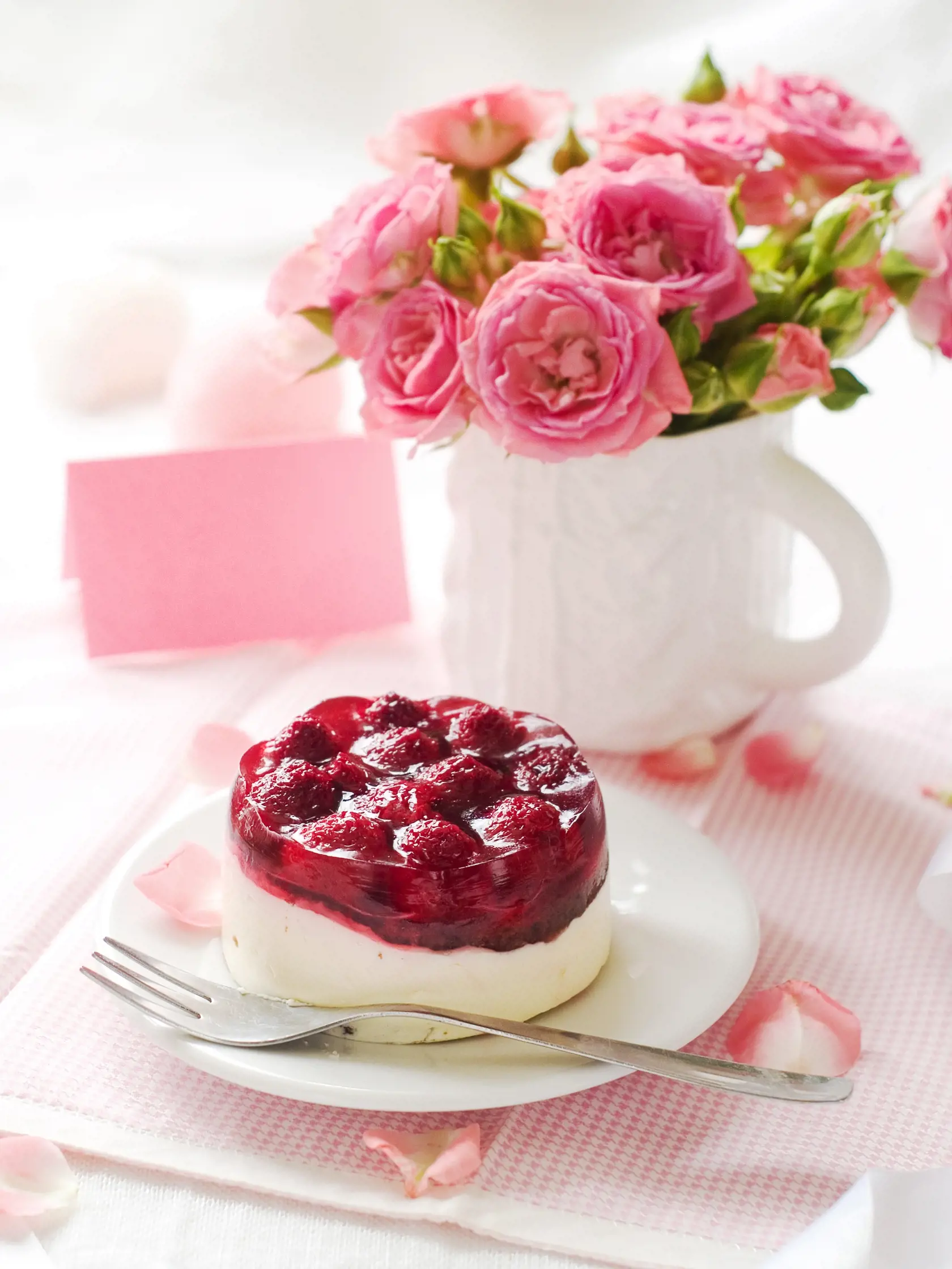 Strawberry cake and pink roses in white cup for celebration, selective focus