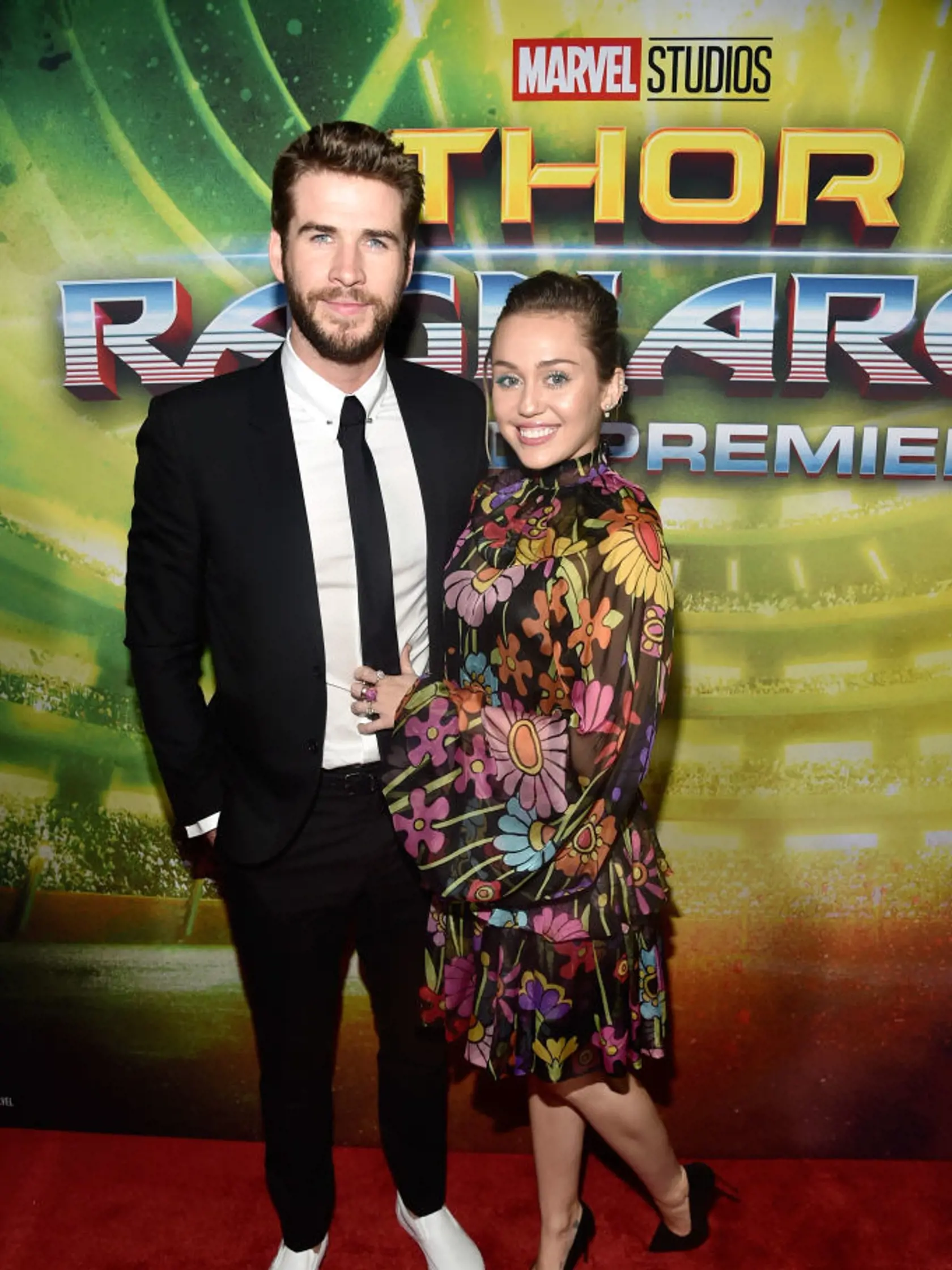 HOLLYWOOD, CA - OCTOBER 10:  Actor Liam Hemsworth (L) and Miley Cyrus at The World Premiere of Marvel Studios' "Thor: Ragnarok" at the El Capitan Theatre on October 10, 2017 in Hollywood, California.  (Photo by Alberto E. Rodriguez/Getty Images for Disney)