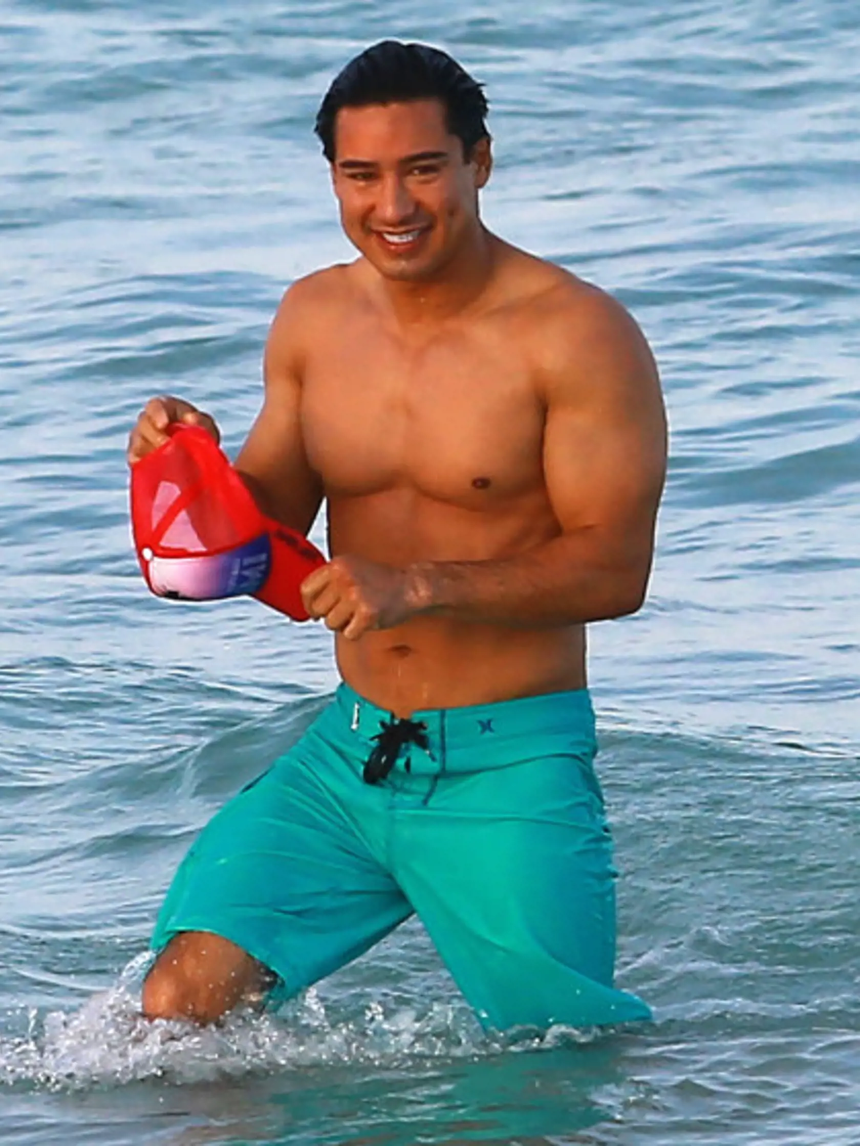 Semi-Exclusive... 51707325 TV personality Mario Lopez shows of his fit physique while enjoying a beach day in Miami, Florida on April 11, 2015. Mario and wife Courtney Mazza were enjoying some down time after attending a Miami Beach Gay Parade press conference. Mario also showed off a gift flag given to him by a fan that was the Mexican Flag with rainbows on the side for gay pride. FameFlynet, Inc - Beverly Hills, CA, USA - +1 (818) 307-4813
