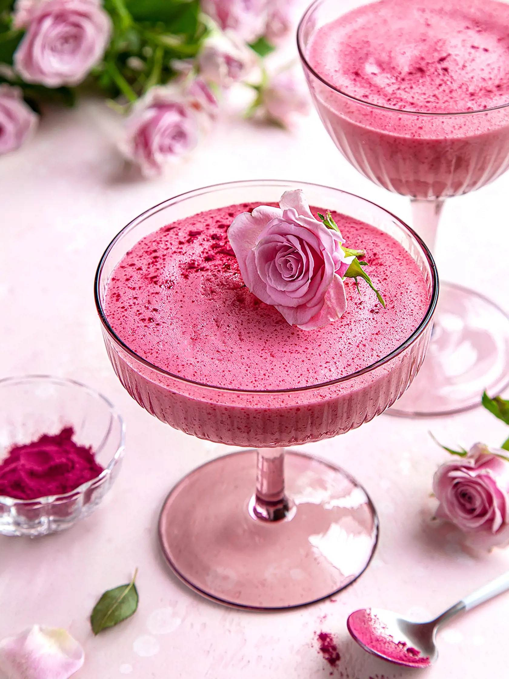 berry mousse in glass, festive dessert, pink background, selective focus